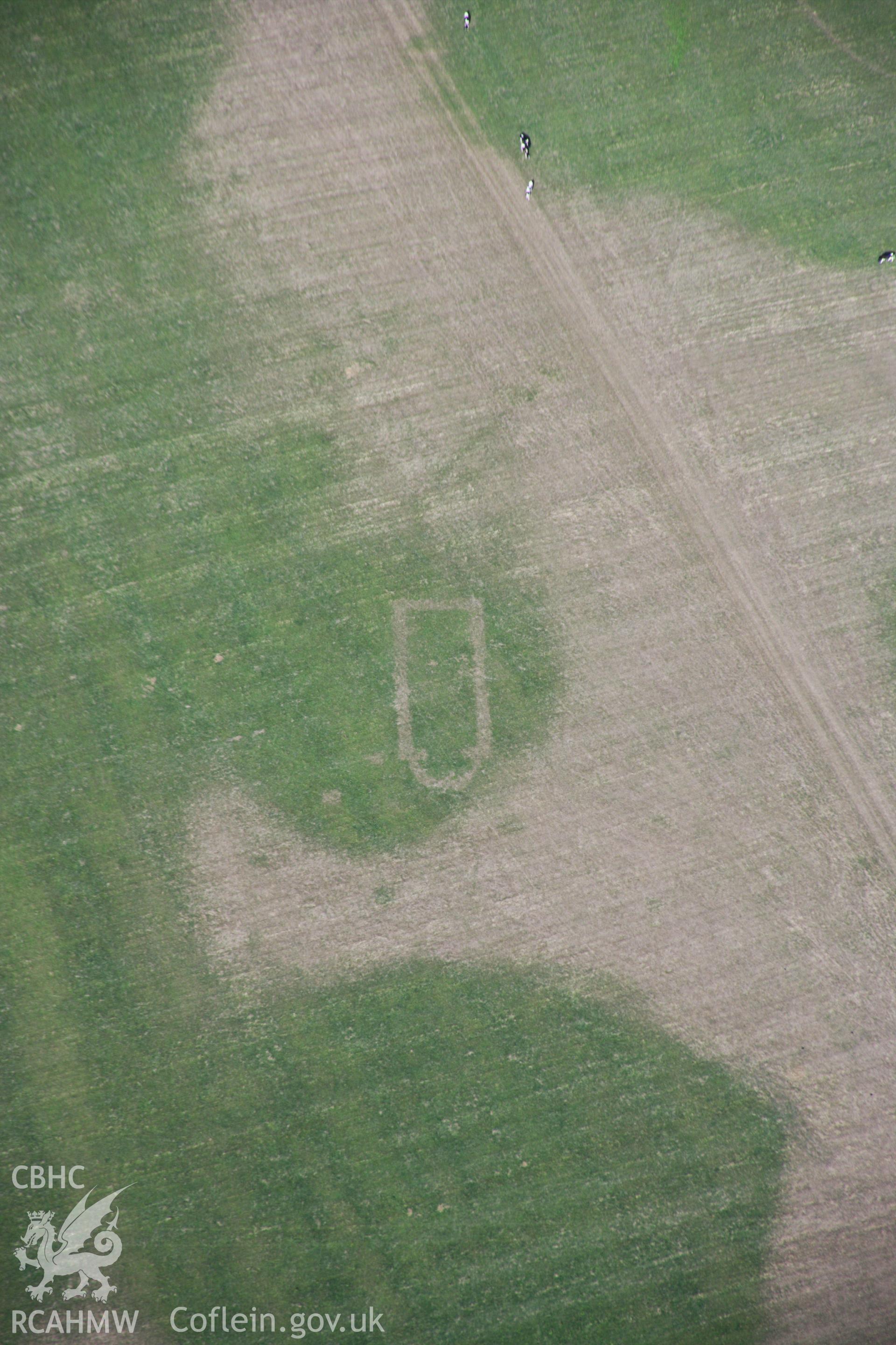 RCAHMW colour oblique aerial photograph of Llwydfaen Medieval Township, site of buried medieval church, view of parched foundations and wider view of township, from south-east, taken on 14/08/2006 by Toby Driver.