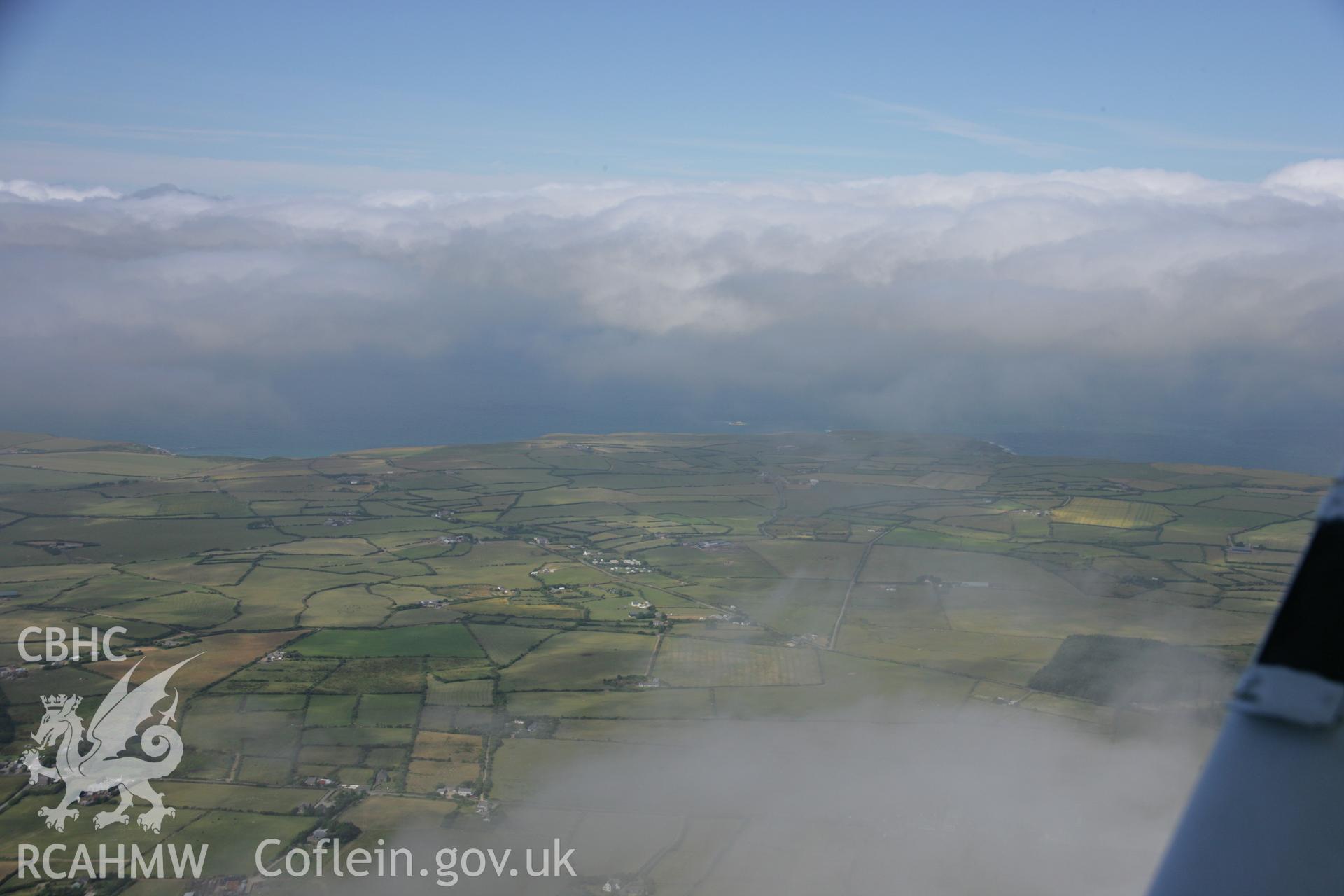 RCAHMW colour oblique aerial photograph of Capel Melyn, Rhydlios. A landscape with summer cloud, looking north-west. Taken on 03 August 2006 by Toby Driver.