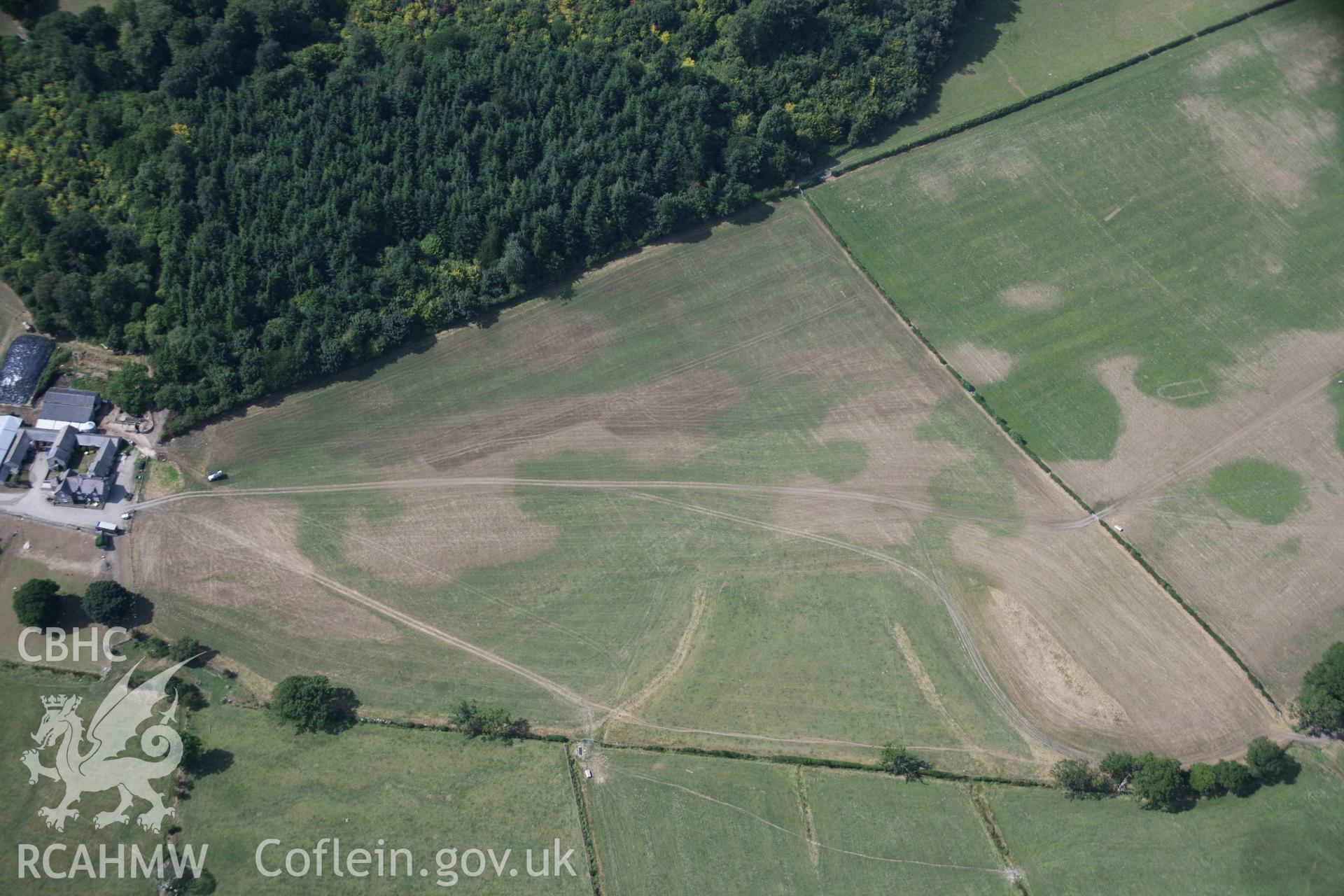 RCAHMW colour oblique aerial photograph of Llwydfaen Medieval Township, general view from the east with parched pasture, taken on 14/08/2006 by Toby Driver.