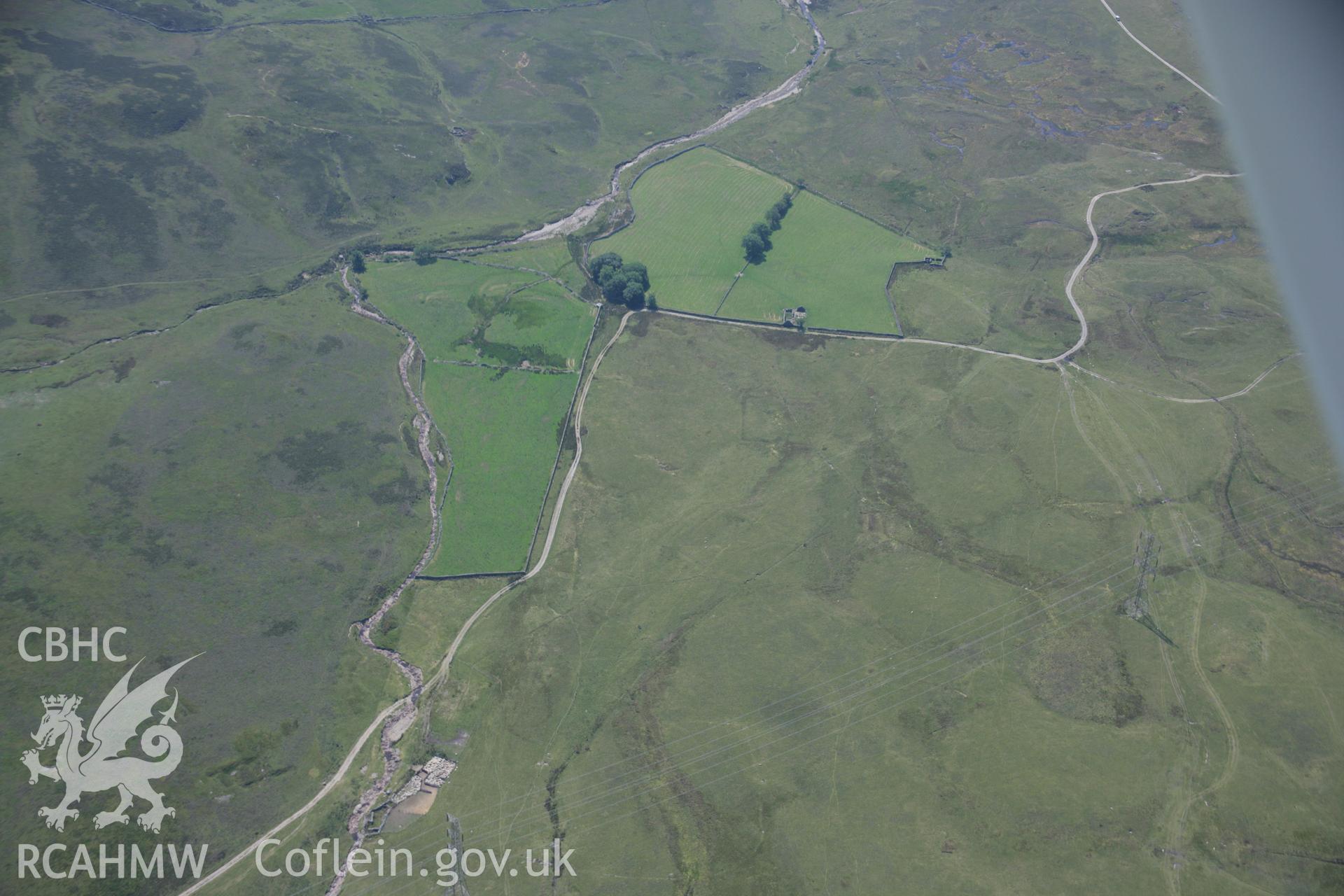 RCAHMW colour oblique aerial photograph of Dolddinas Camps. Taken on 18 July 2006 by Toby Driver