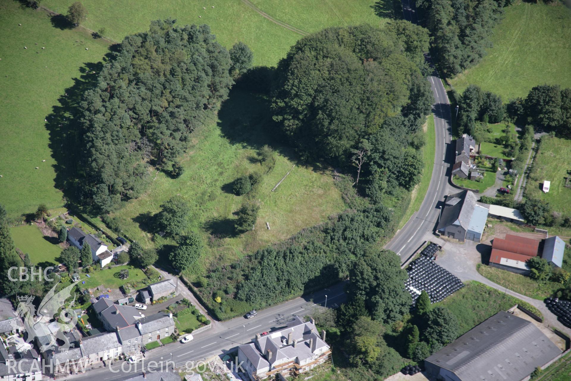 RCAHMW colour oblique aerial photograph of Trecastle Motte and the village from the south. Taken on 02 September 2005 by Toby Driver