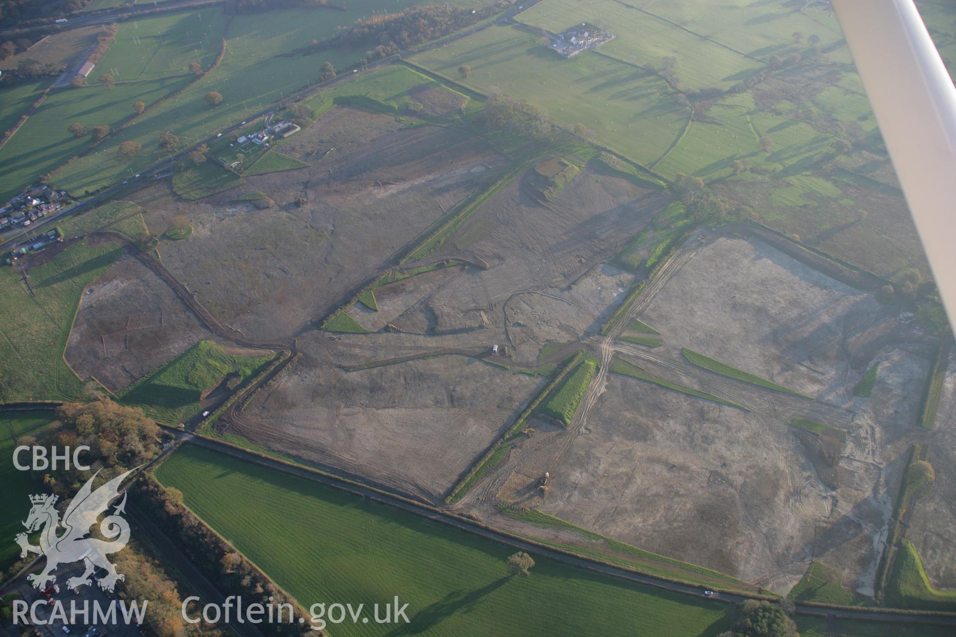RCAHMW colour oblique aerial photograph of Parc Bryn Cegin prehistoric settlements under excavation by Gwynedd Archaeological Trust, viewed looking to the south-east. Taken on 21 November 2005 by Toby Driver