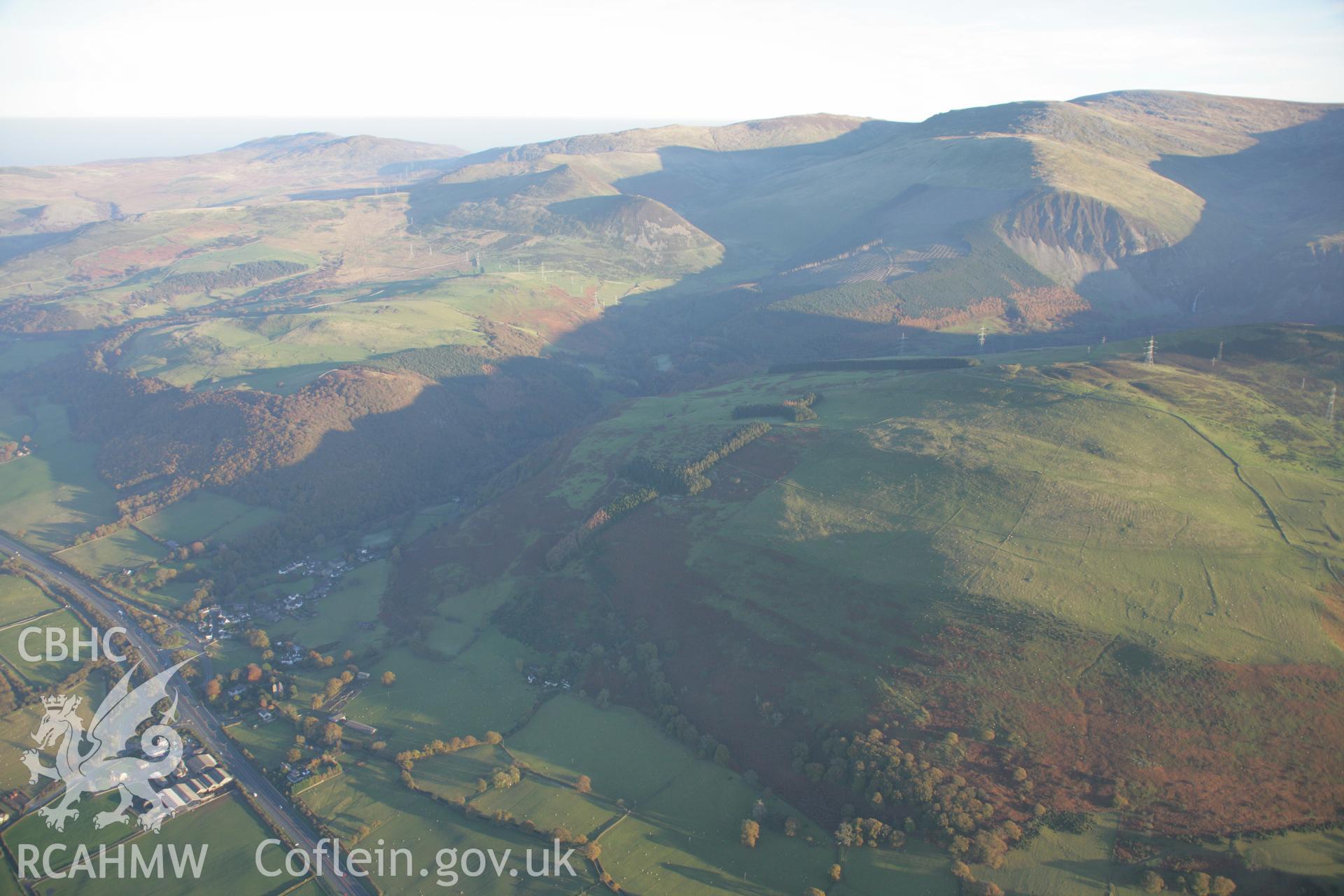 RCAHMW colour oblique aerial photograph of Aber Castle or Pen-y-Mwd Mound viewed from the west with the mountain landscape beyond. Taken on 21 November 2005 by Toby Driver
