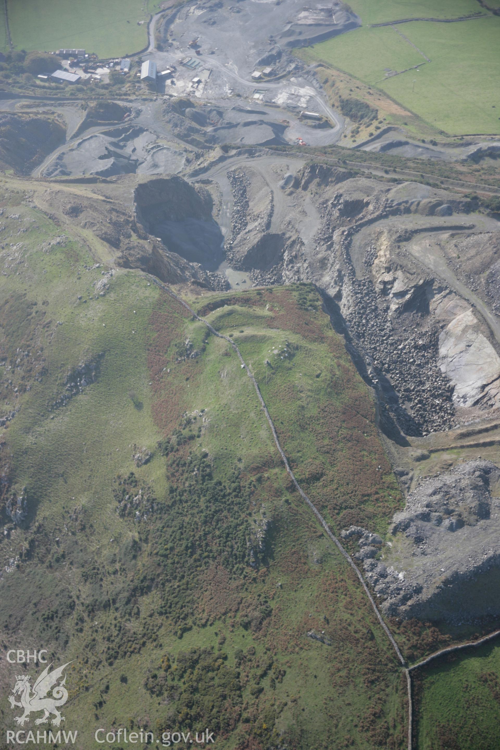 RCAHMW colour oblique aerial photograph of Tal-y-Gareg Hillfort and nearby quarry from the north-east. Taken on 17 October 2005 by Toby Driver