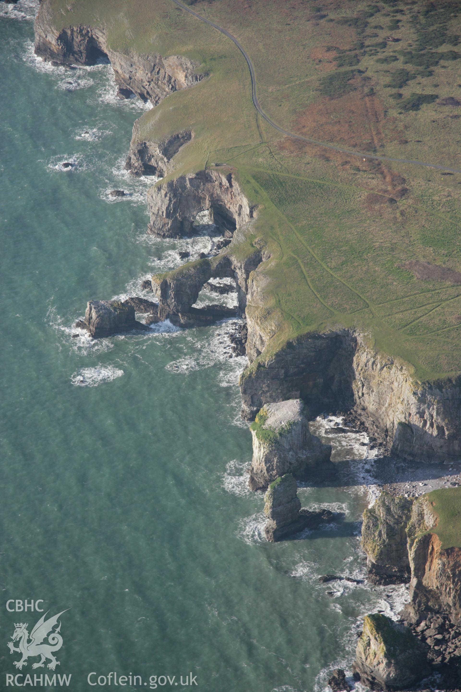 RCAHMW colour oblique aerial photograph of the Green Bridge (of Wales) and Elegug Stacks showing the coastal landscape from the east. Taken on 19 November 2005 by Toby Driver