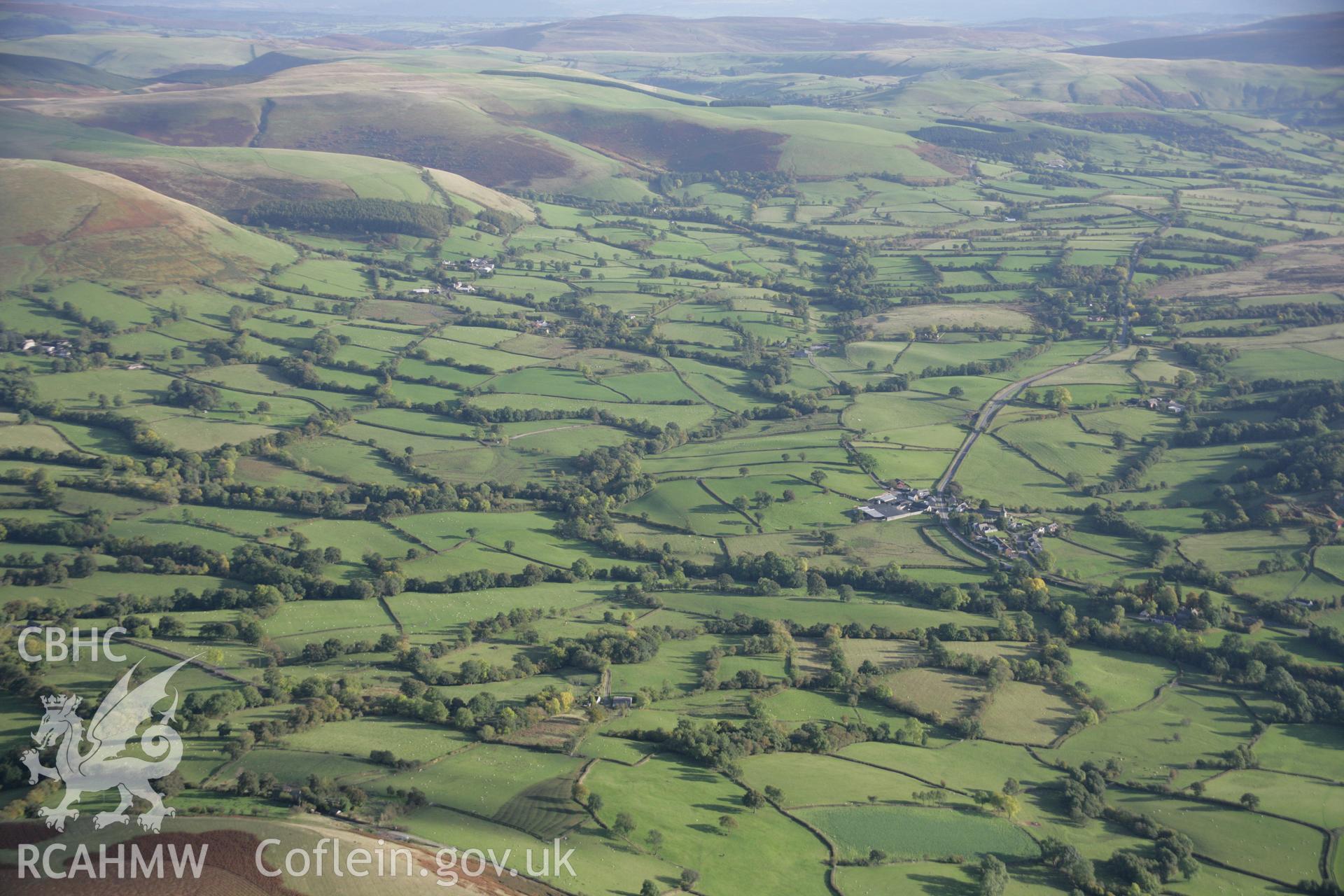 RCAHMW colour oblique aerial photograph of St Tecla's Church, Llandegley. A wide landscape view from the north-west. Taken on 13 October 2005 by Toby Driver