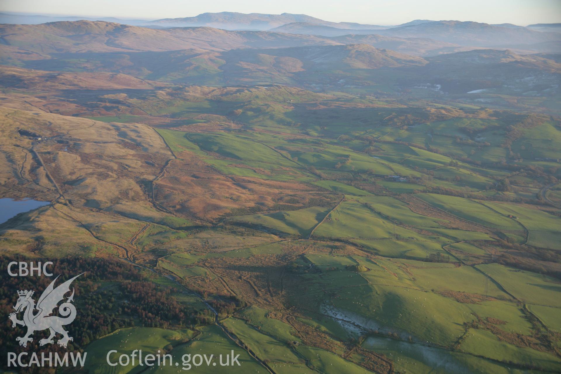 RCAHMW colour oblique aerial photograph of Tomen y Mur Roman Military Settlement. A wide winter landscape view from the north-west. Taken on 21 November 2005 by Toby Driver