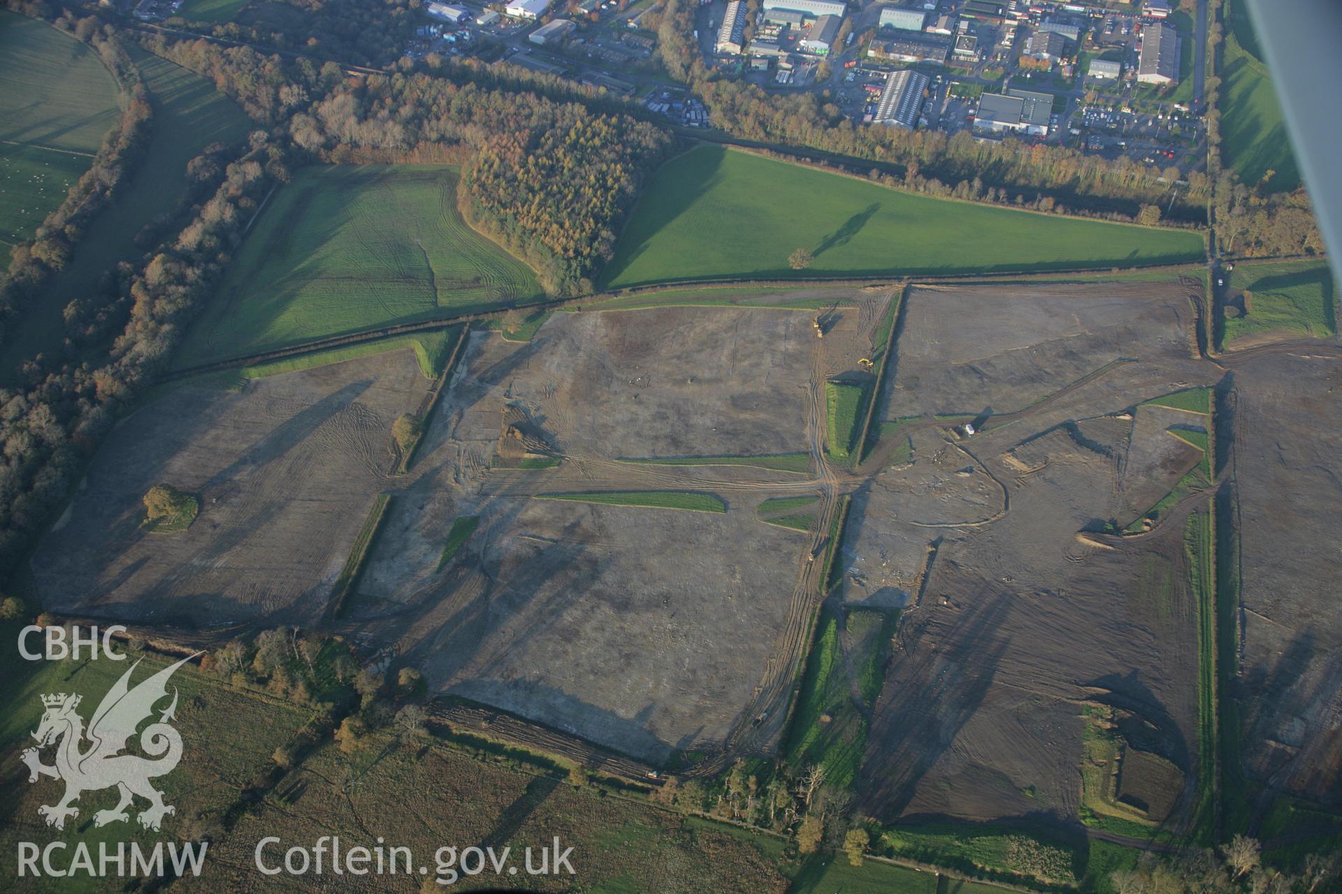 RCAHMW colour oblique aerial photograph of Parc Bryn Cegin prehistoric settlements under excavation by Gwynedd Archaeological Trust, viewed looking to the north. Taken on 21 November 2005 by Toby Driver