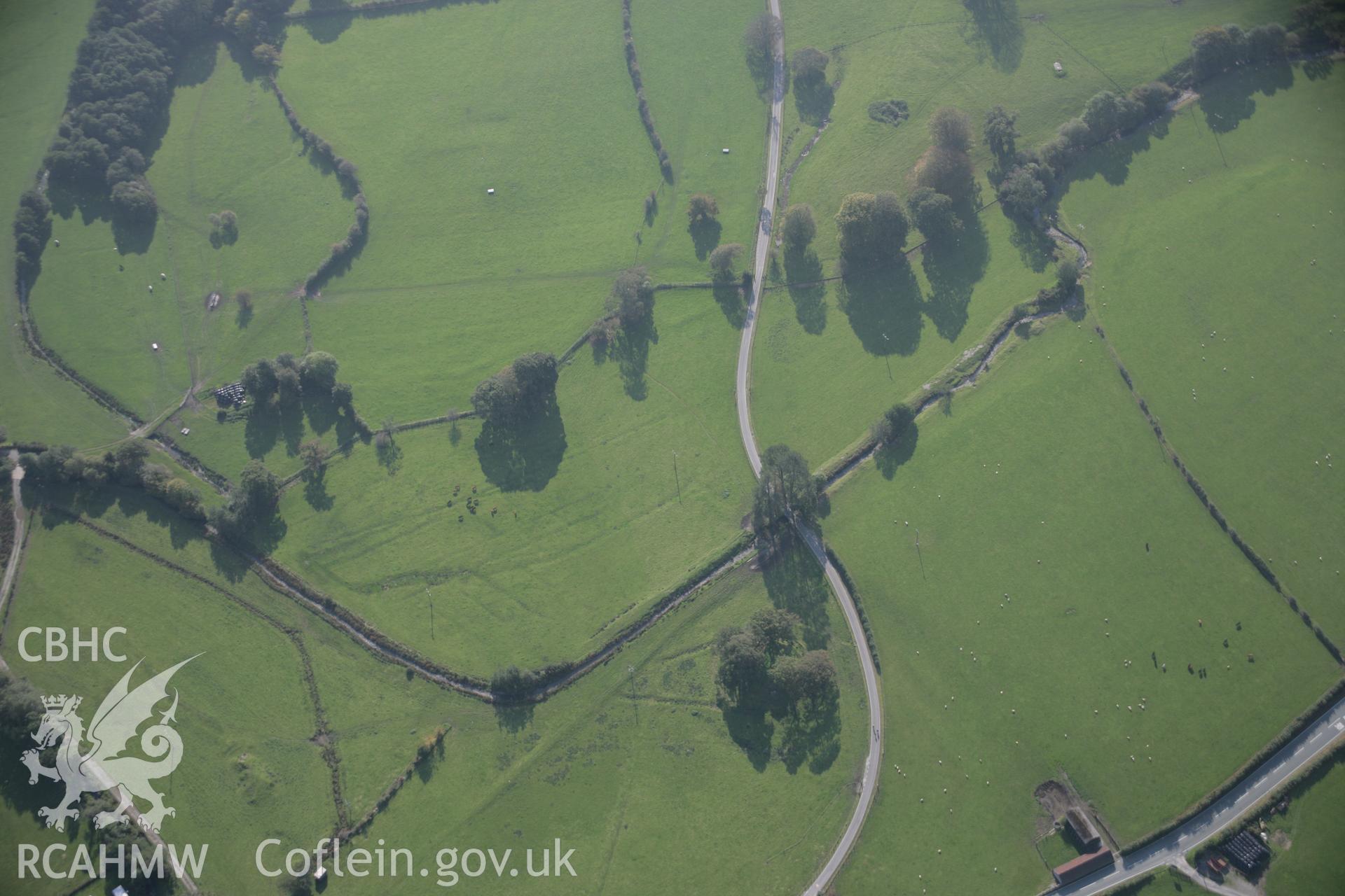 RCAHMW colour oblique aerial photograph of Tomen Las and surrounding earthworks from the north-west. Taken on 17 October 2005 by Toby Driver