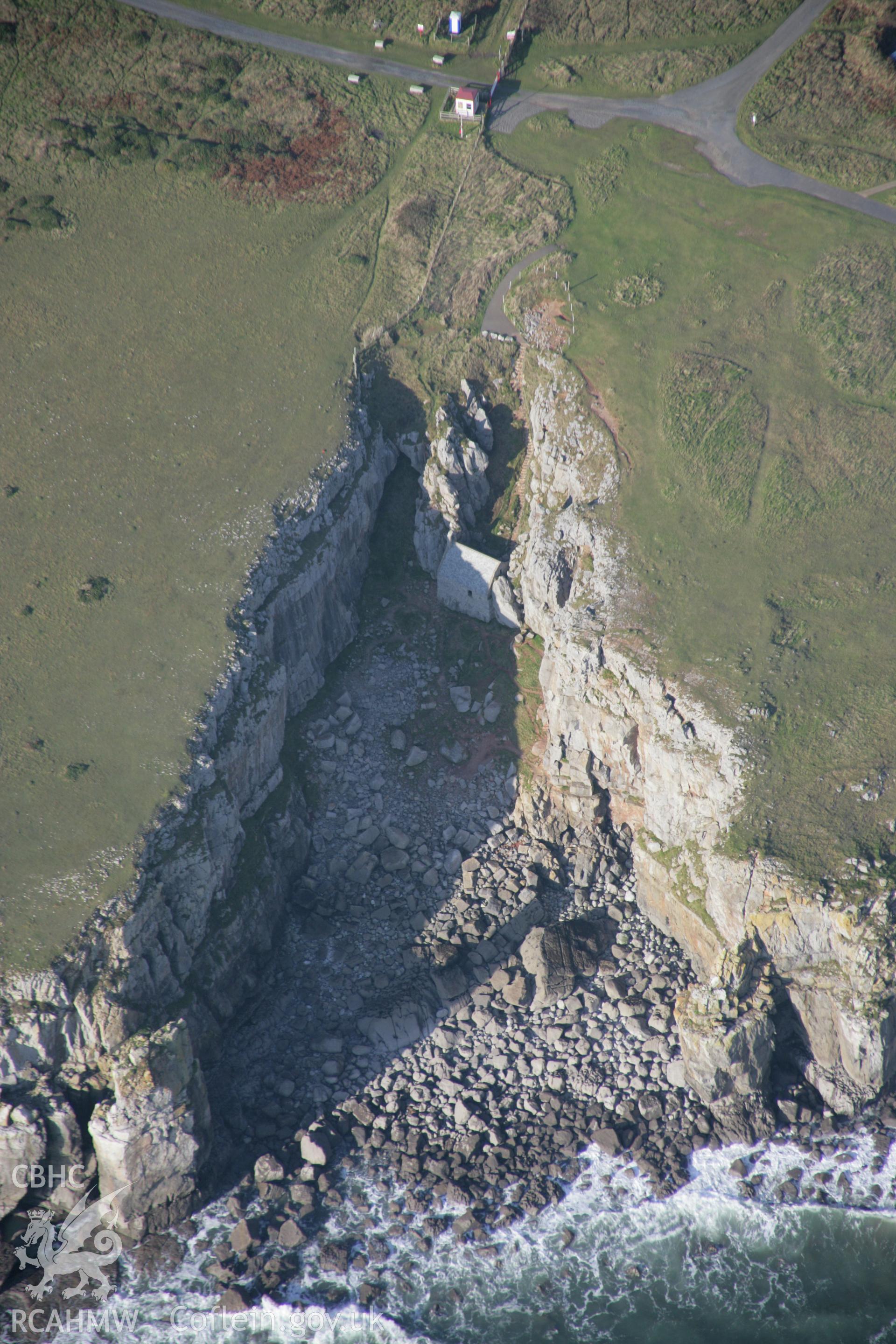 RCAHMW colour oblique aerial photograph of St Govan's Chapel and nearby well, from the south-east. Taken on 19 November 2005 by Toby Driver