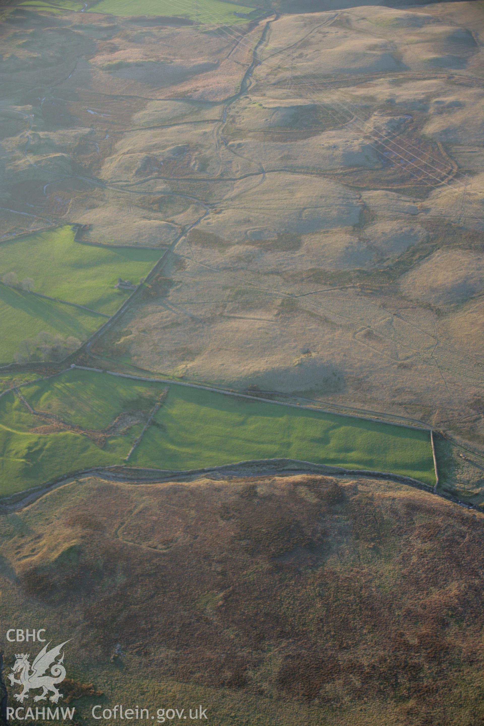 RCAHMW colour oblique aerial photograph of Roman practice camps, Dolddinas I, III, IV and V viewed from the east. Taken on 21 November 2005 by Toby Driver