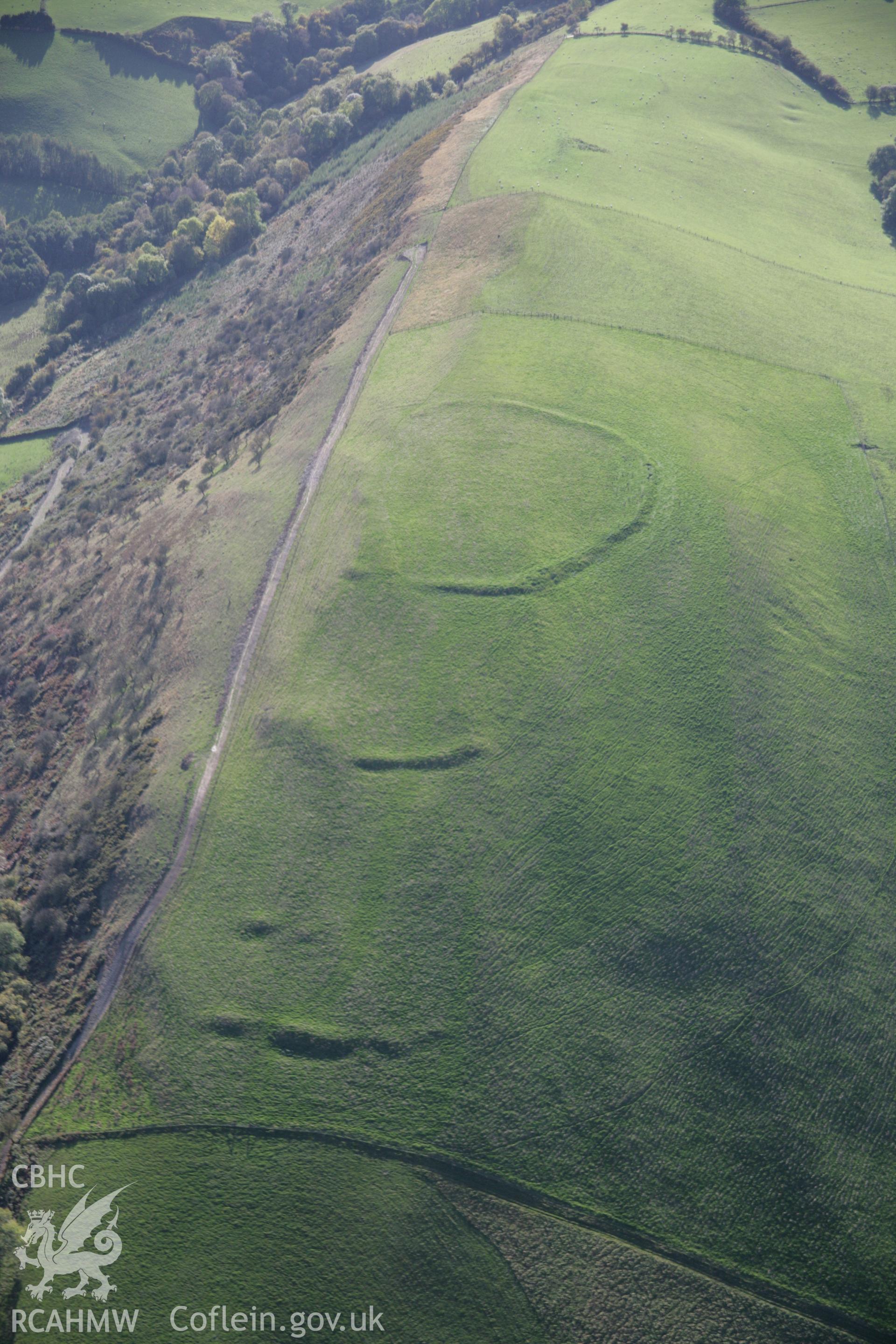 RCAHMW colour oblique aerial photograph of Llyssin Hill Hillfort and outworks and Crossdykes, viewed looking west. Taken on 13 October 2005 by Toby Driver