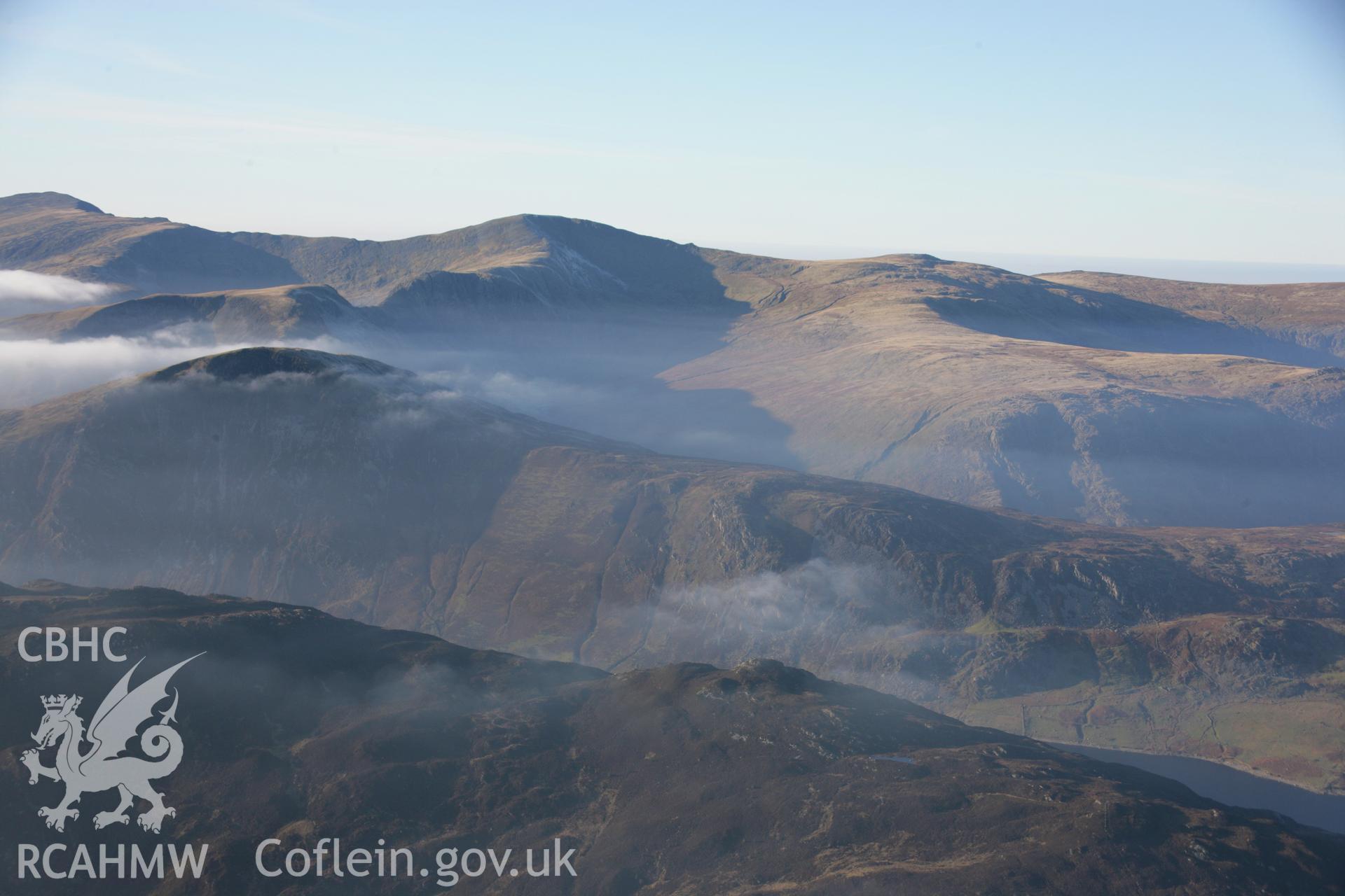 RCAHMW colour oblique aerial photograph of Llyn Cowlyd and Pen Llithrigy Wrach shown in non-archaeological mountain landscape with mist, from south-east. Dust specks are visible from the digital sensor. Taken on 21 November 2005 by Toby Driver