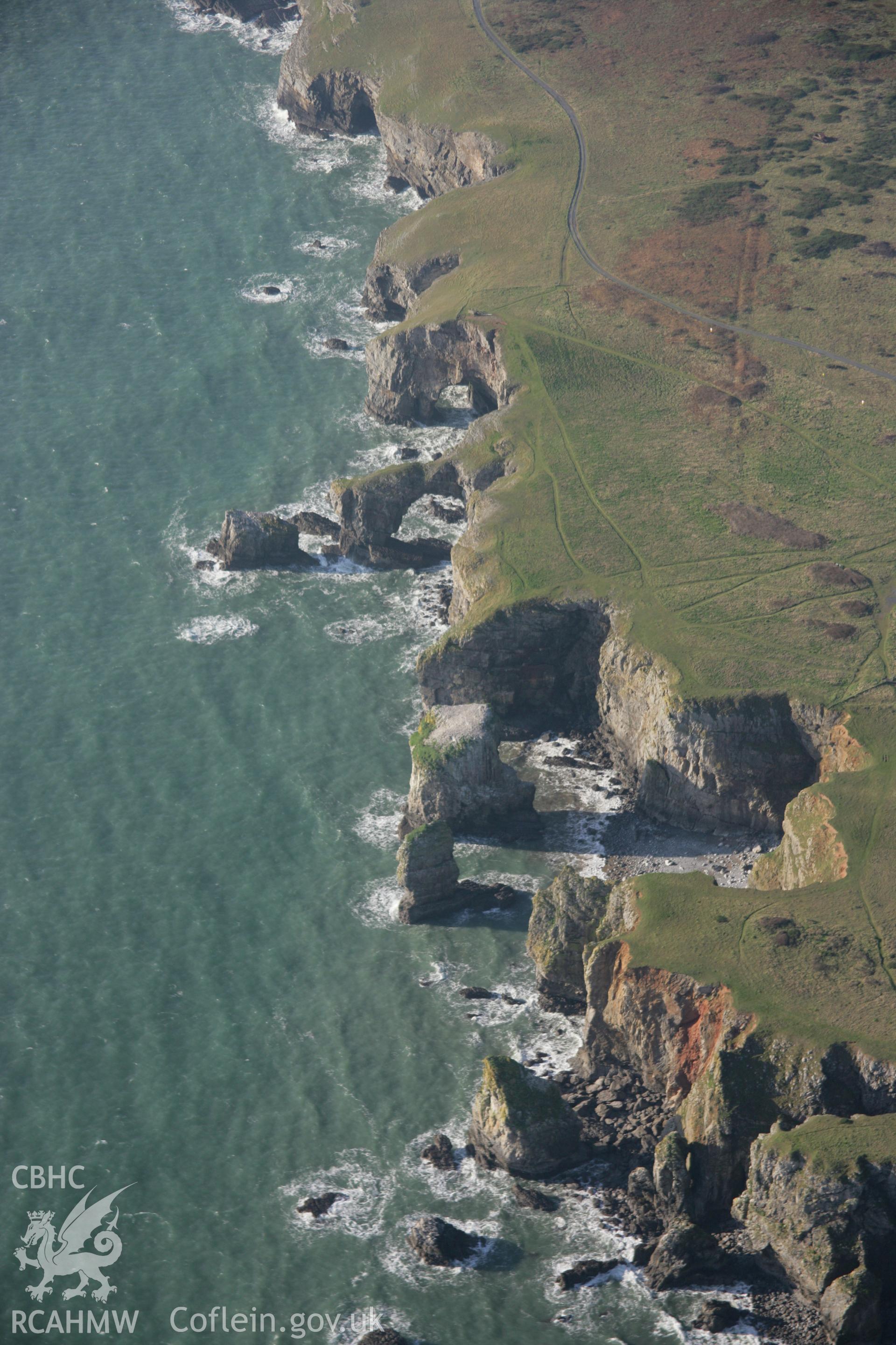 RCAHMW colour oblique aerial photograph of the Green Bridge (of Wales) and Elegug Stacks from the east. Taken on 19 November 2005 by Toby Driver