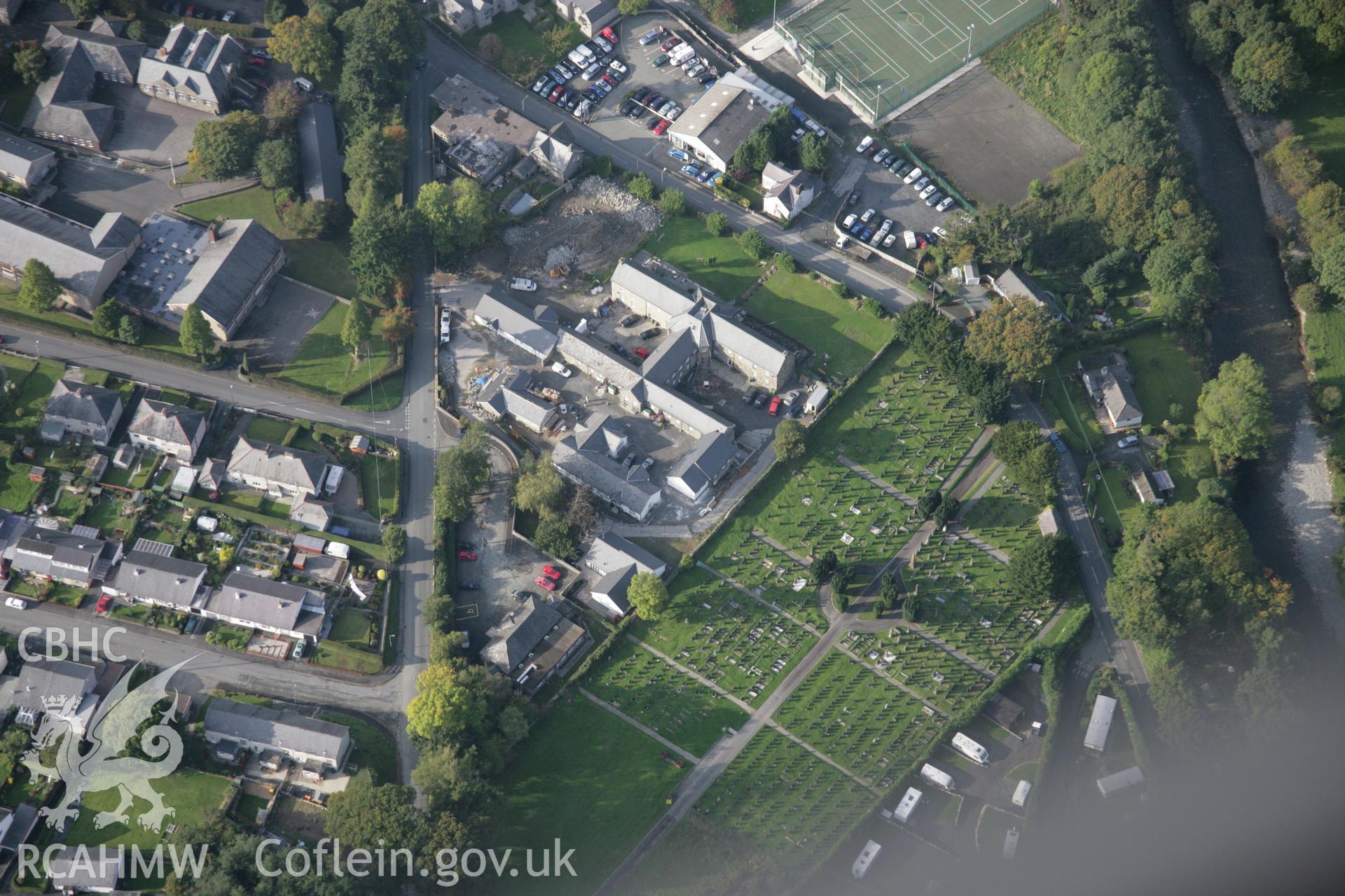 RCAHMW colour oblique aerial photograph of Dolgelley Union Workhouse and cemetery, Dolgellau, viewed from the south-east. Taken on 17 October 2005 by Toby Driver