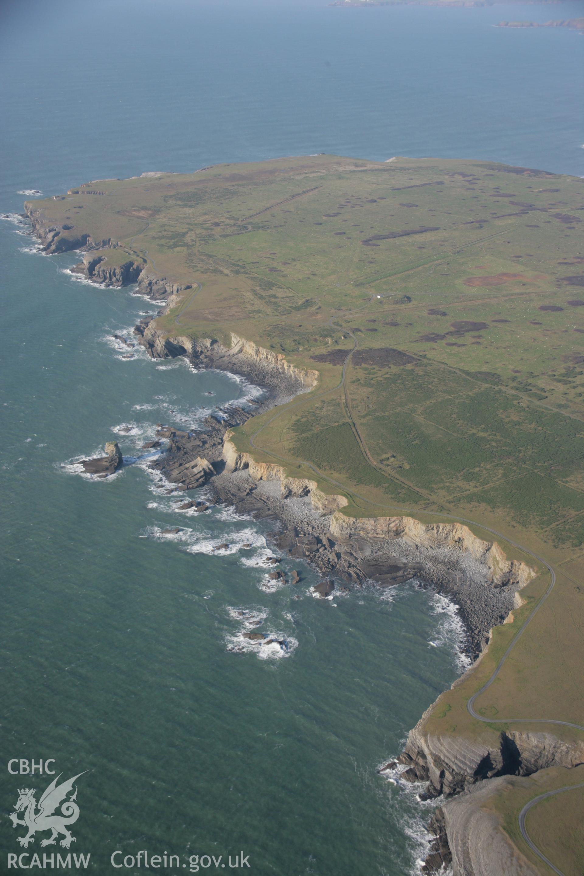 RCAHMW colour oblique aerial photograph of Castlemartin Training Area looking west towards Linney Head showing Pen-y-Holt Down and the coastal landscape. Taken on 19 November 2005 by Toby Driver