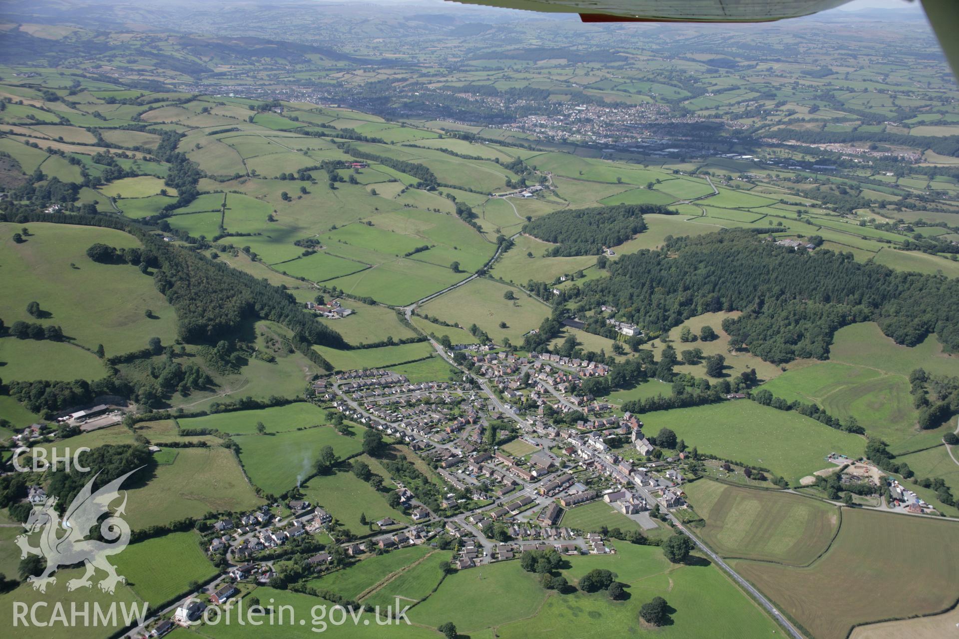 RCAHMW colour oblique aerial photograph of Kerry village showing a general view from the south-east. Taken on 02 September 2005 by Toby Driver