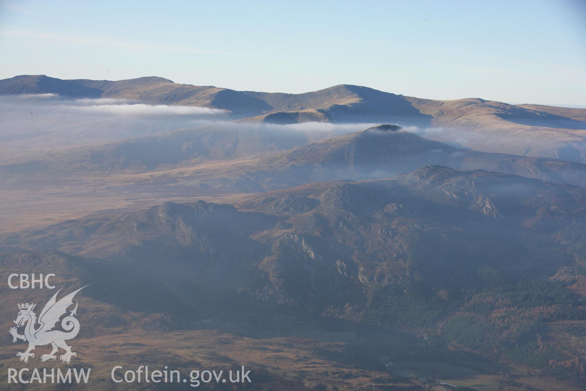 RCAHMW colour oblique aerial photograph of Llyn Cowlyd and Pen Llithrigy Wrach shown in non-archaeological mountain landscape with mist, from south-east. Dust specks are visible from the digital sensor. Taken on 21 November 2005 by Toby Driver