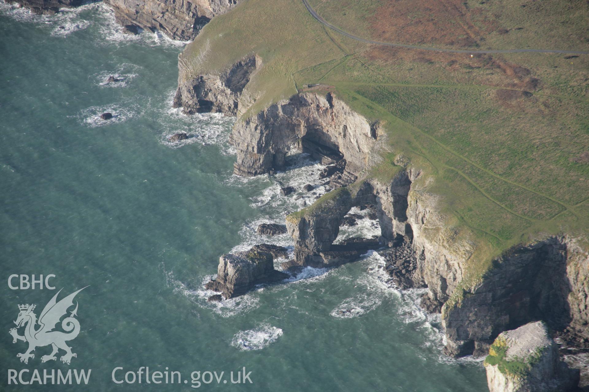 RCAHMW colour oblique aerial photograph of the Green Bridge (of Wales) and Elegug Stacks showing the limestone arch from the south-east. Taken on 19 November 2005 by Toby Driver