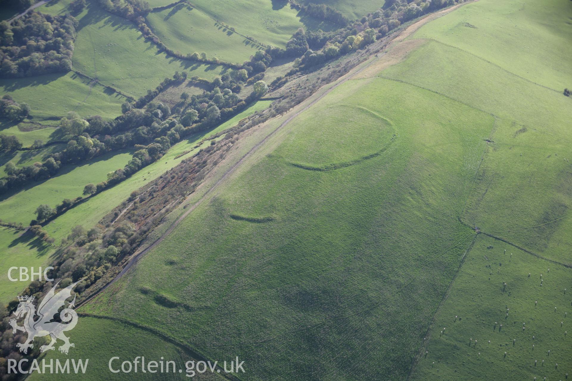 RCAHMW colour oblique aerial photograph of Llyssin Hill Hillfort and outworks with Crossdykes, viewed looking to the south-west Taken on 13 October 2005 by Toby Driver