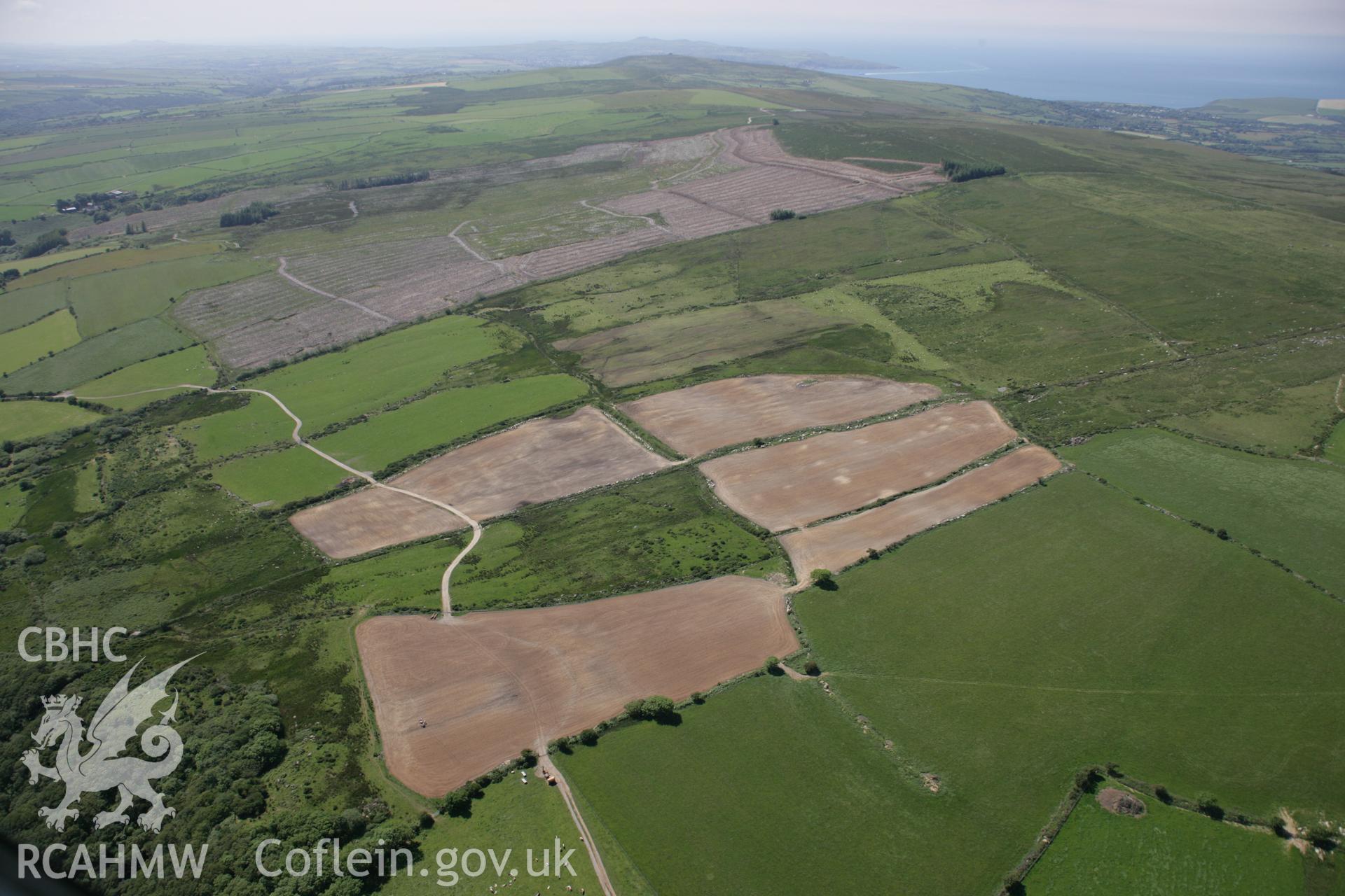 RCAHMW colour oblique aerial photograph of fields south of Carn-ingli Common, after heavy ploughing, Gallt Llanerch. Taken on 23 June 2005 by Toby Driver