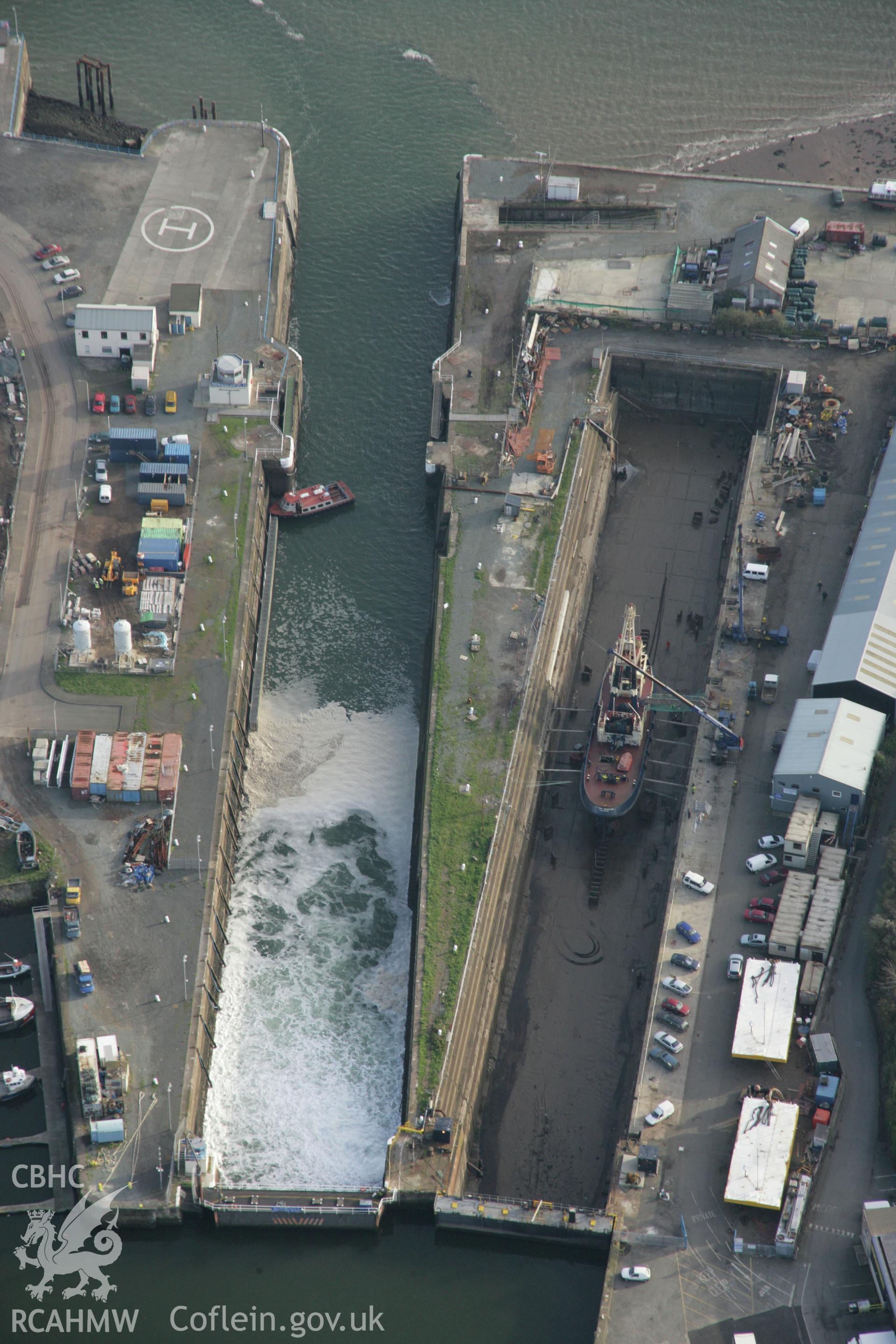 RCAHMW colour oblique photograph of Milford Haven Dockyard, view of docks and sluice gates from north-west. Taken by Toby Driver on 17/11/2005.