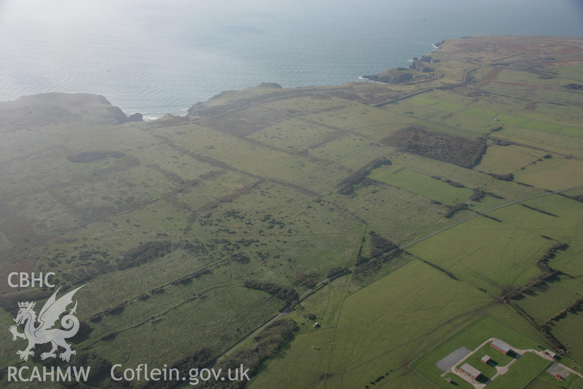 RCAHMW colour oblique aerial photograph of Castlemartin Training Area. A landscape view looking south-west over Longstone Down to Bullslaughter Bay. Taken on 19 November 2005 by Toby Driver