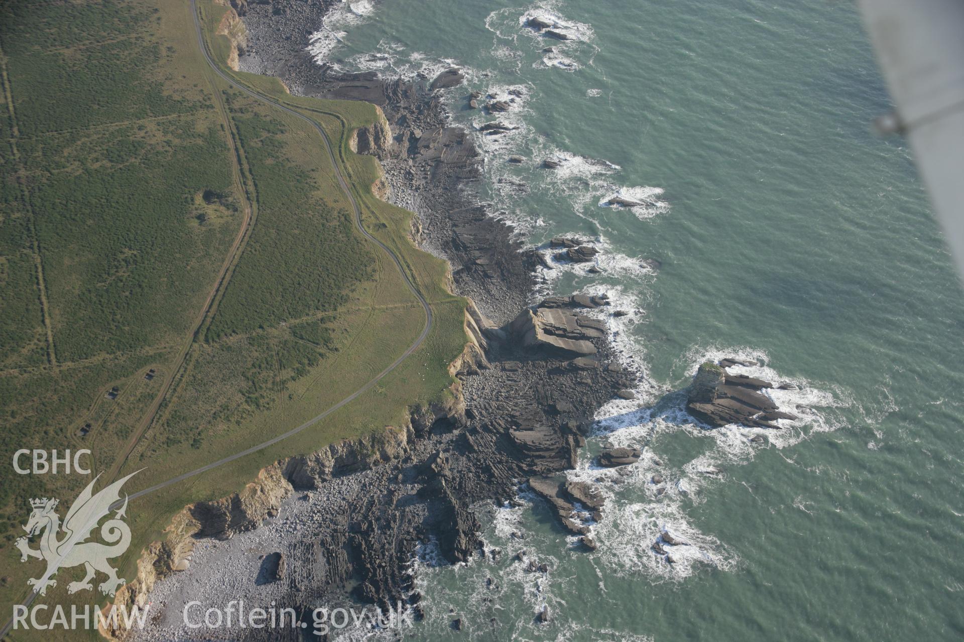 RCAHMW colour oblique aerial photograph of Castlemartin Training Area looking east showing Pen-y-Holt Down and the coastal landscape. Taken on 19 November 2005 by Toby Driver