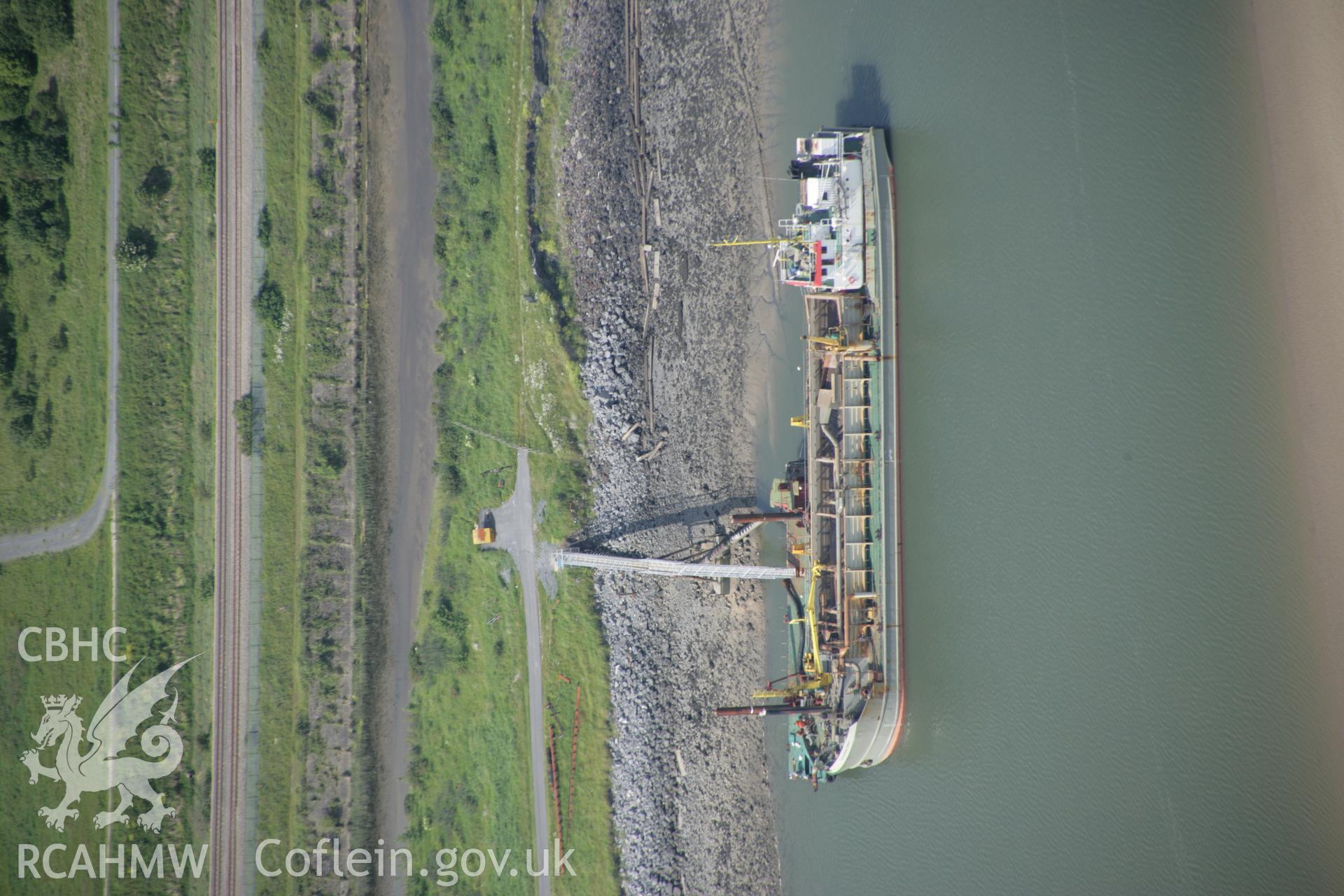 RCAHMW colour oblique aerial photograph of Burry Port with a tanker docked to the east of the town. Taken on 09 June 2005 by Toby Driver