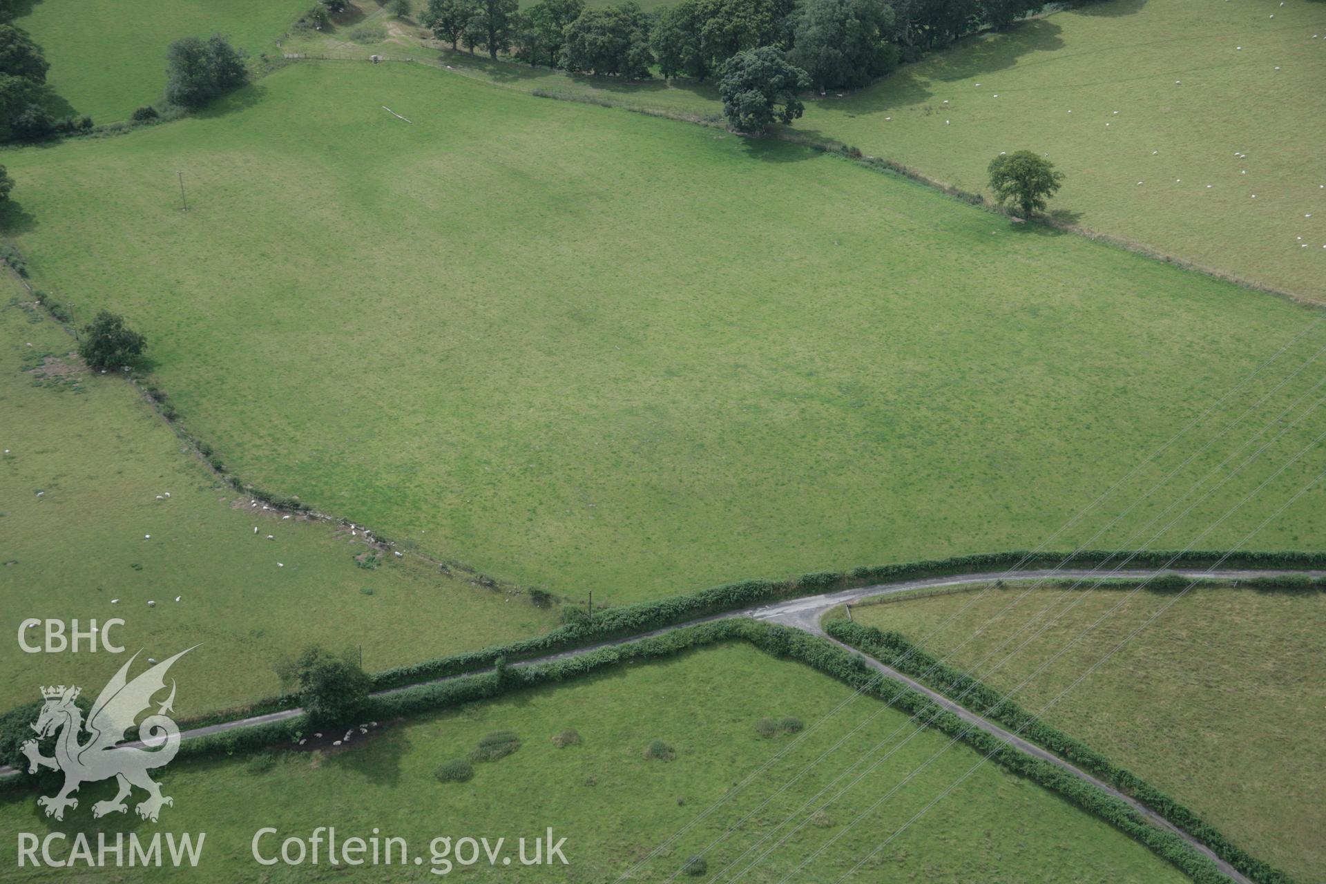 RCAHMW digital colour oblique photograph of Ty'n-y-Wern Hillfort visible as a faint cropmark viewed from the north-east. Taken on 01/08/2005 by T.G. Driver.