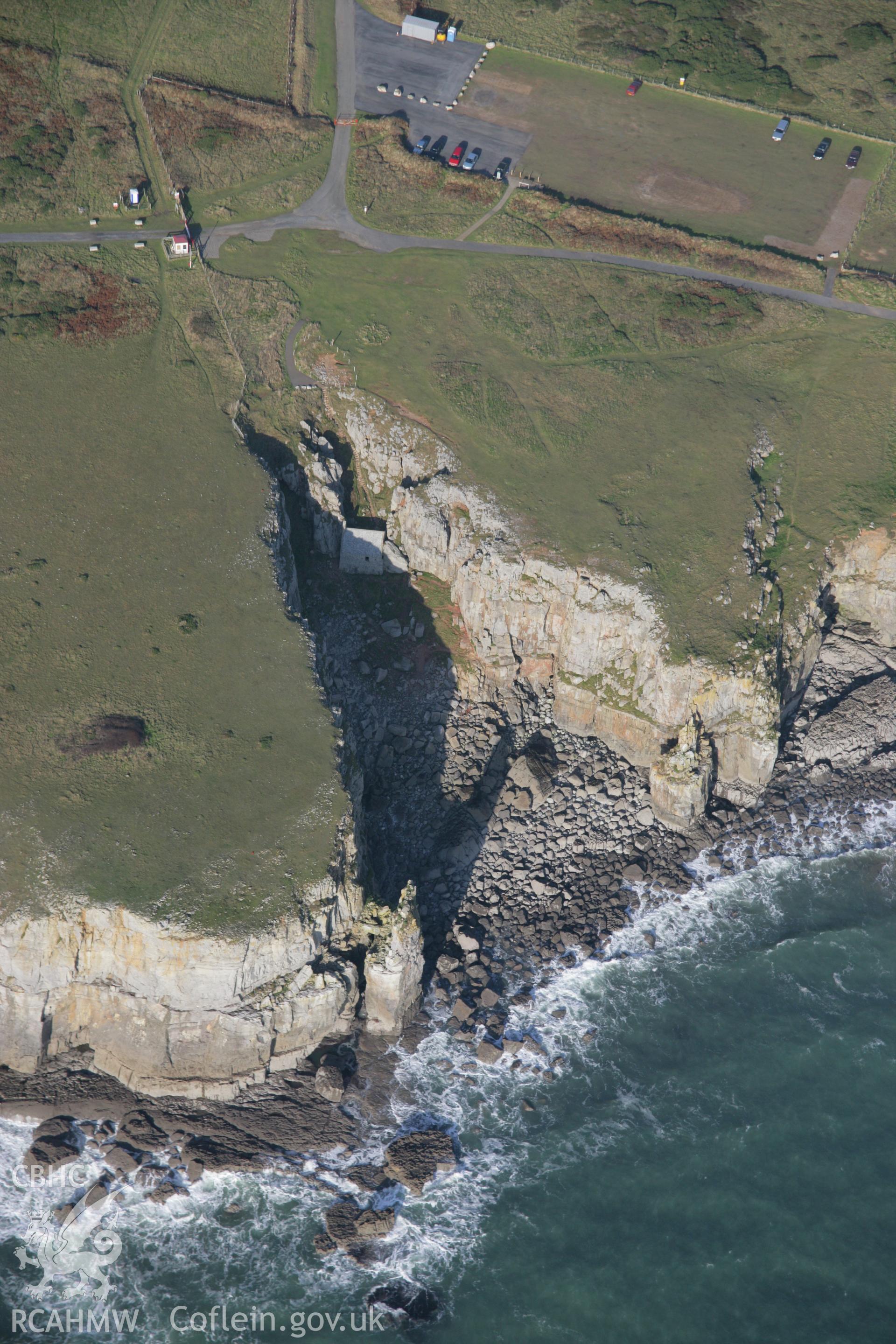 RCAHMW colour oblique aerial photograph of St Govan's Chapel and nearby well, from the south. Taken on 19 November 2005 by Toby Driver