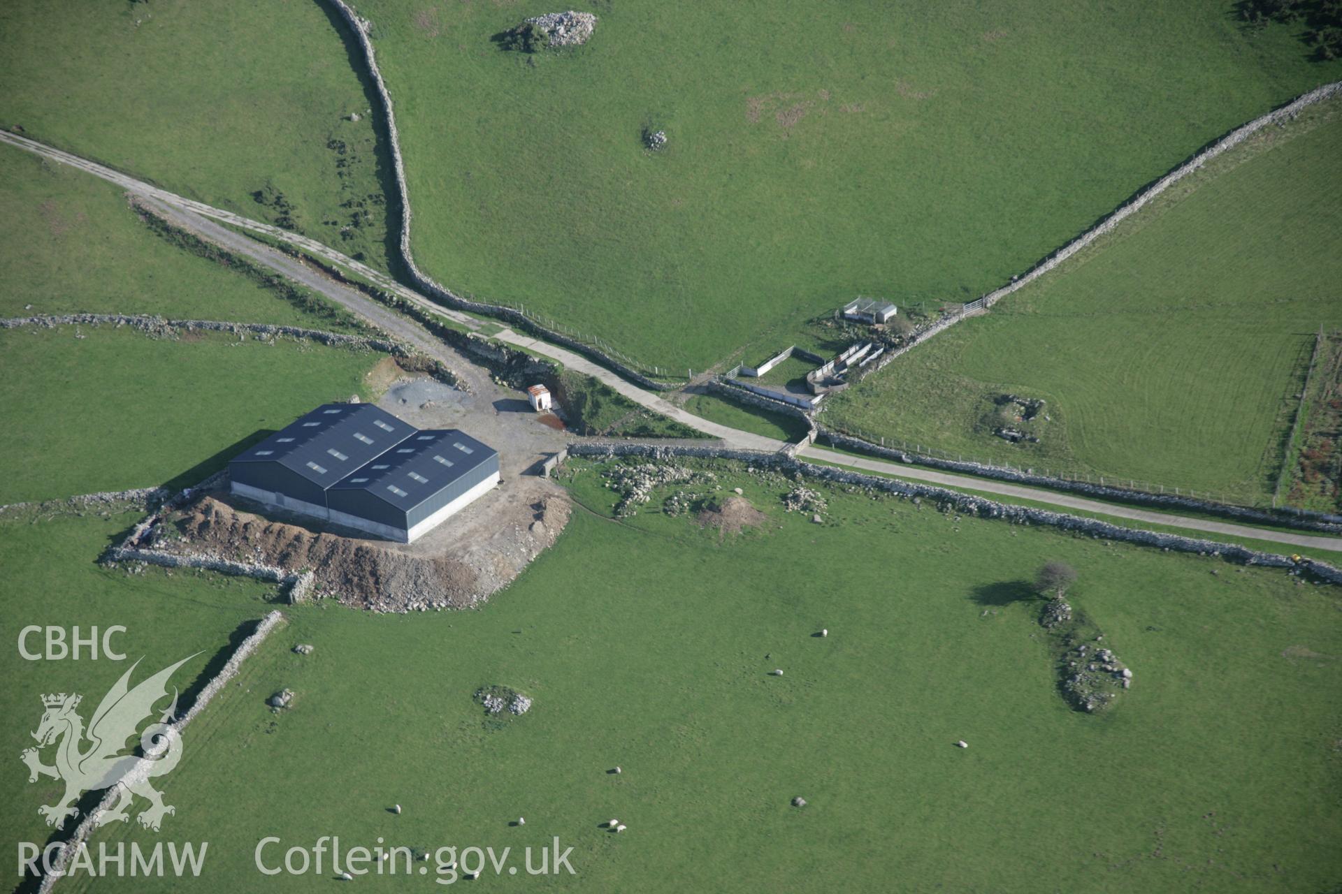 RCAHMW colour oblique aerial photograph of Carn-Gadell Uchaf Corn Drying Kiln, Llwyngwril, from the north-west showing new agricultural sheds. Taken on 17 October 2005 by Toby Driver