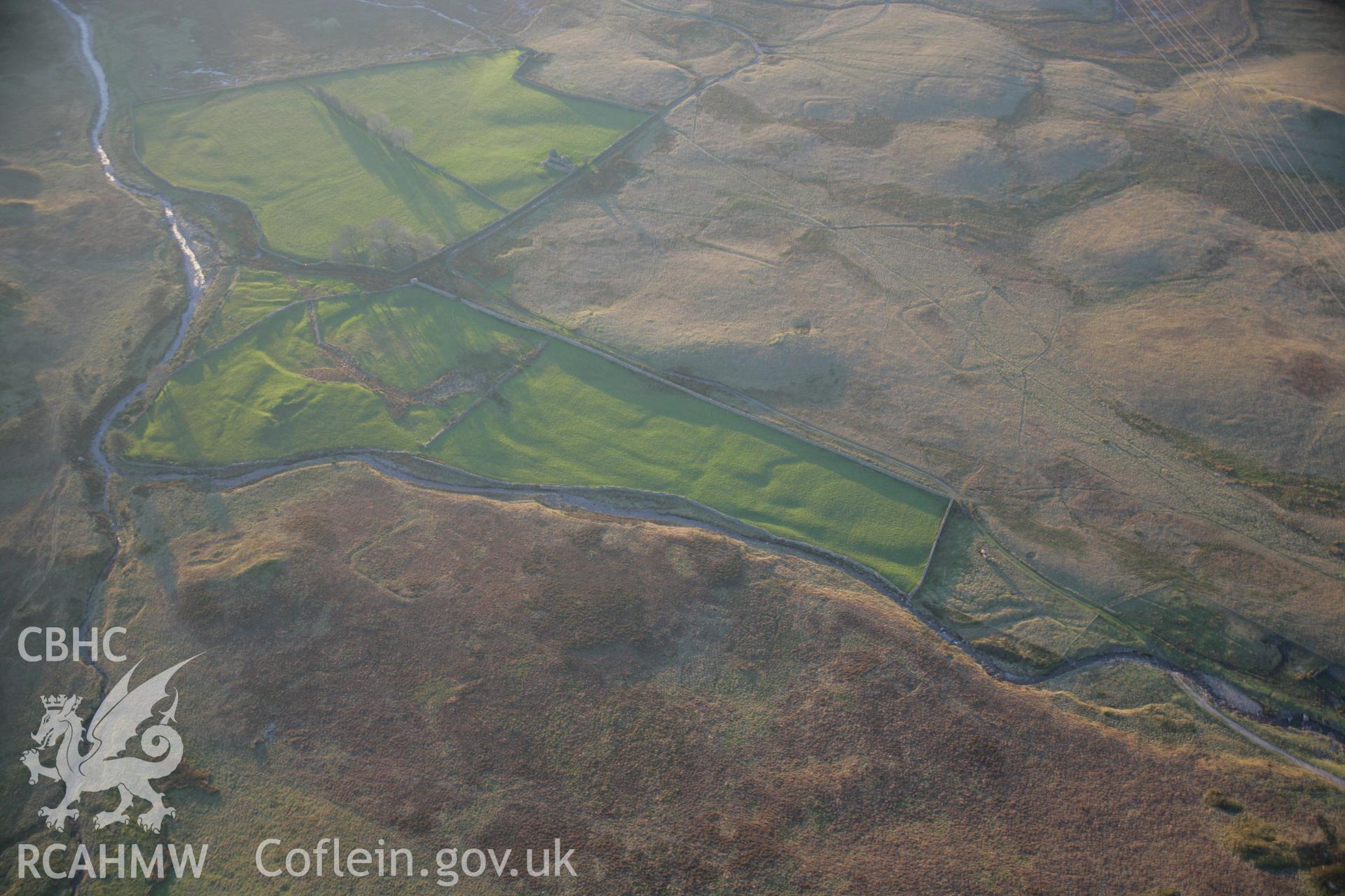 RCAHMW colour oblique aerial photograph of Roman practice camps, Dolddinas I, III, IV and V viewed from the north-east. Taken on 21 November 2005 by Toby Driver