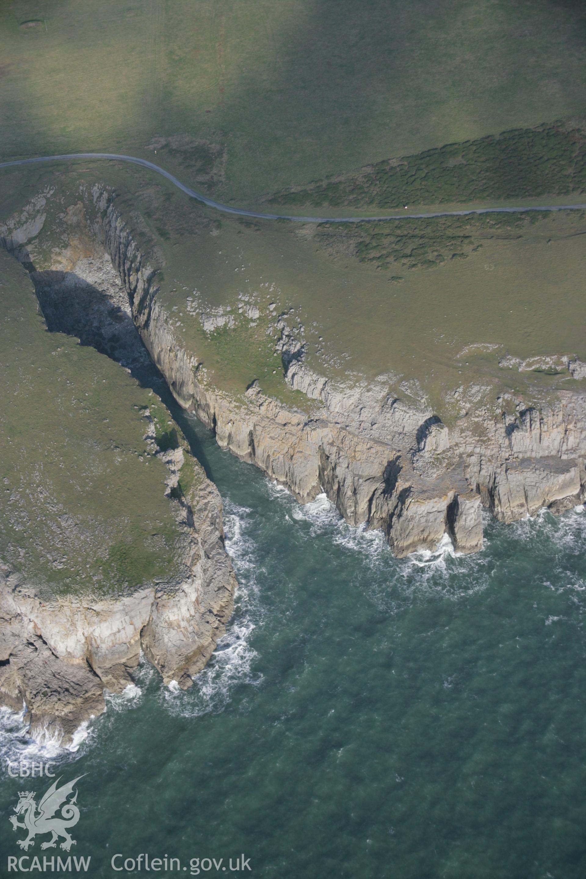 RCAHMW colour oblique aerial photograph of Castlemartin Training Area from the south showing Newton Down and coastal cliffs. Taken on 19 November 2005 by Toby Driver