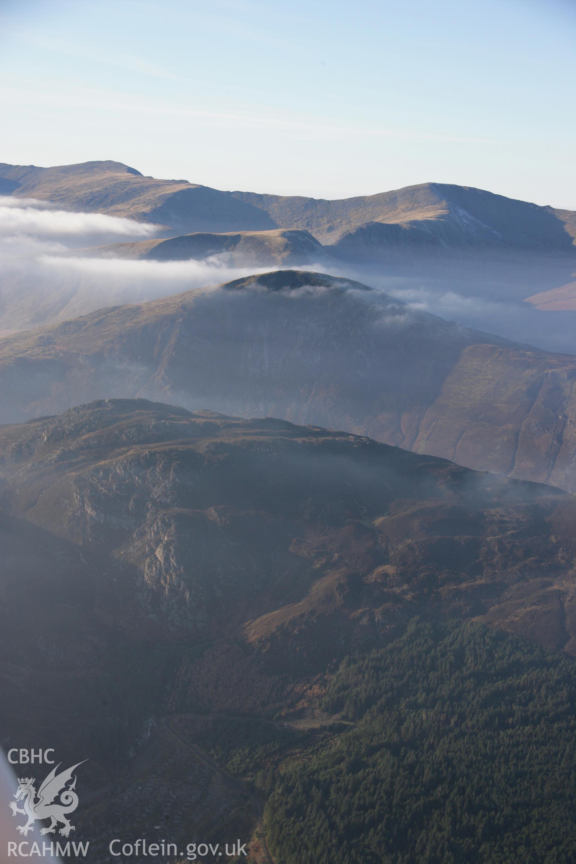 RCAHMW colour oblique aerial photograph of Llyn Cowlyd and Pen Llithrigy Wrach, shown in non-archaeological mountain landscape with mist, from south-east. Dust specks are visible from the digital sensor. Taken on 21 November 2005 by Toby Driver