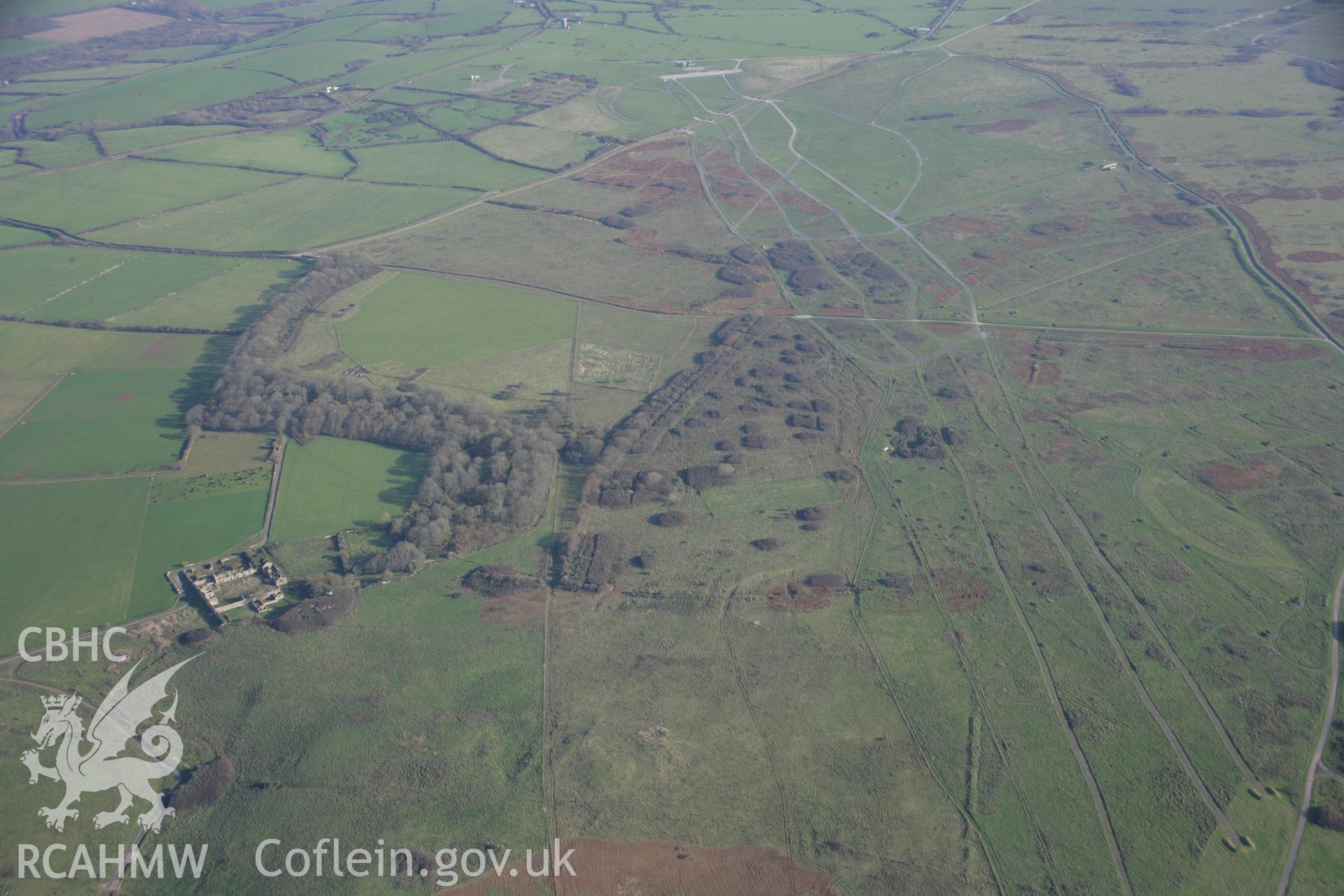 RCAHMW colour oblique aerial photograph of Brownslade Round Barrow, and early medieval cemetery, Castlemartin, in wide landscape view from the west. Taken on 19 November 2005 by Toby Driver