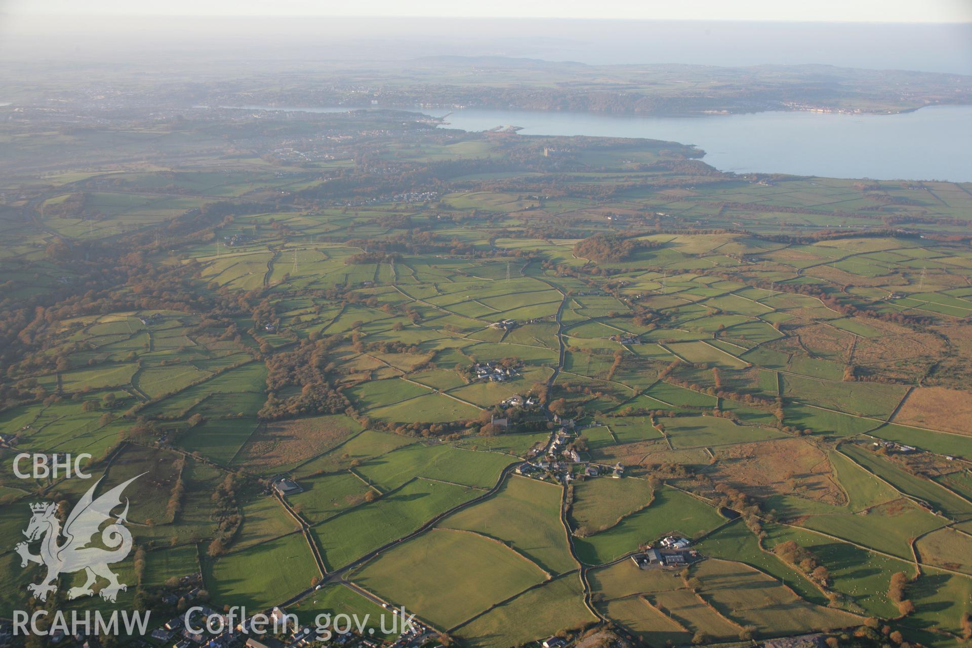 RCAHMW colour oblique aerial photograph of Llanllechid Welsh Calvinistic Methodist Chapel with landscape view to the north-west over village towards Menai Straits. Taken on 21 November 2005 by Toby Driver