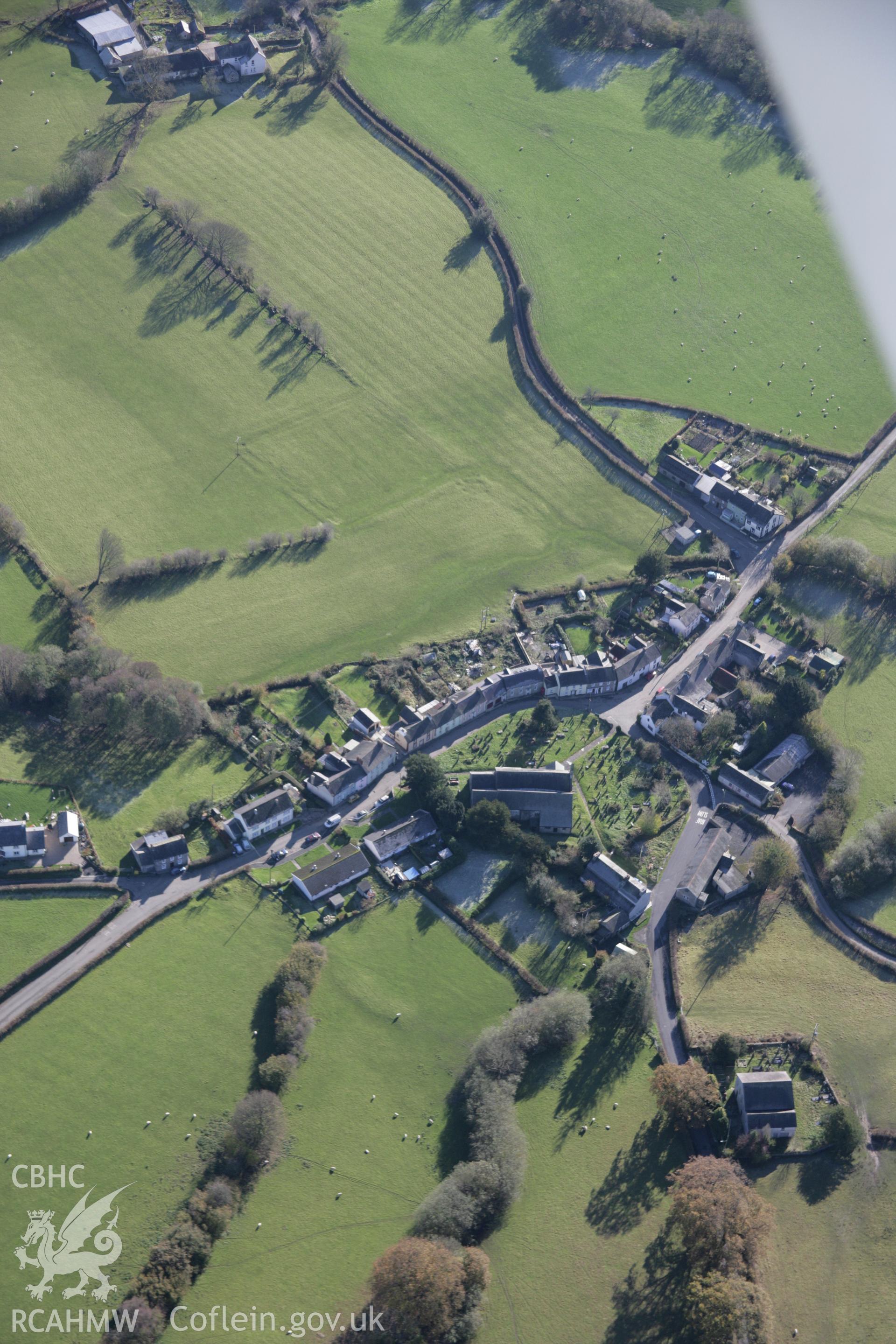 RCAHMW colour oblique photograph of Myddfai, St Michael's Church, with earthworks of former outer enclosure, view from north-west. Taken by Toby Driver on 17/11/2005.