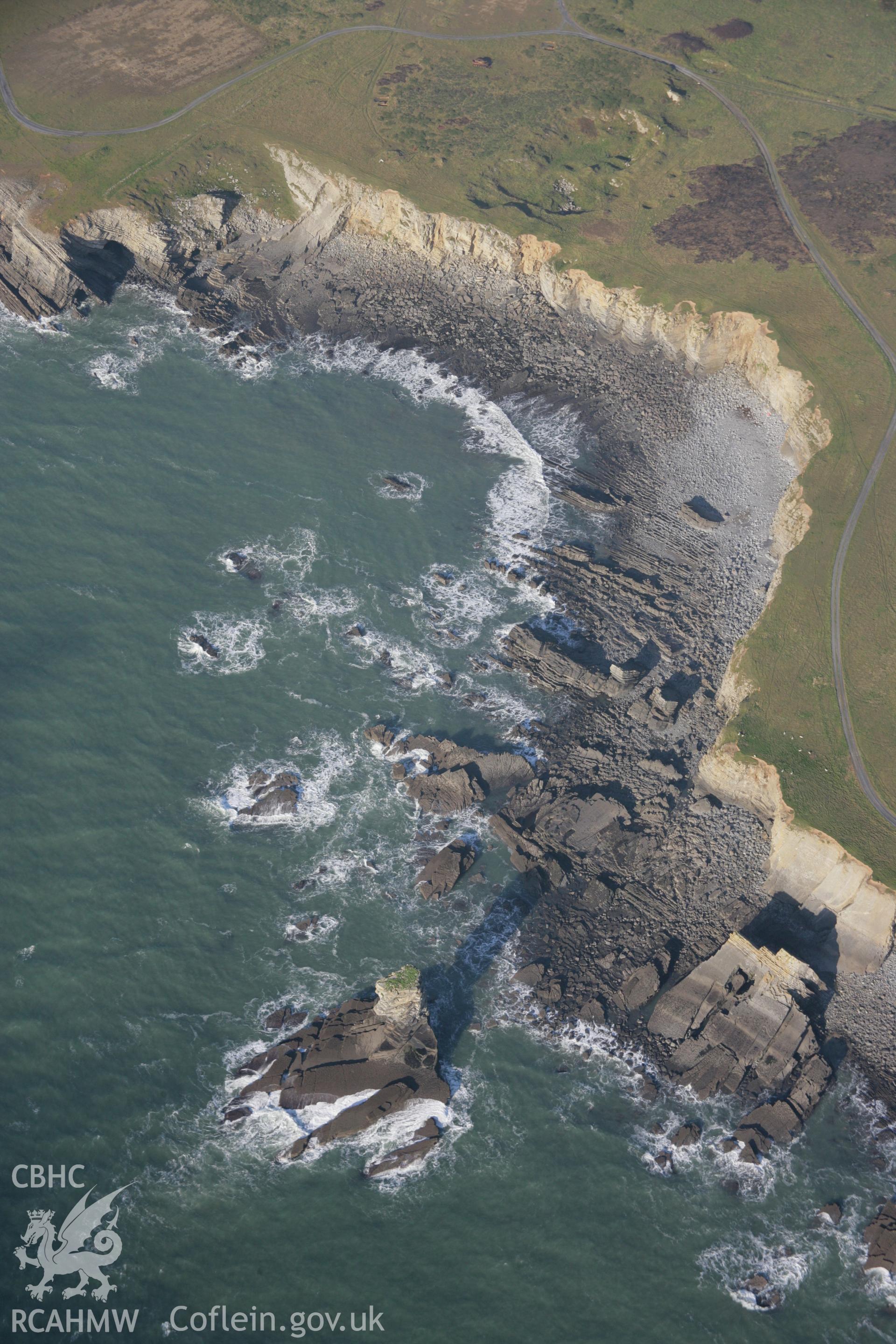 RCAHMW colour oblique aerial photograph of Castlemartin Training Area showing Pen-y-holt Stack, the bay, and the coastal landscape from the south-east. Taken on 19 November 2005 by Toby Driver