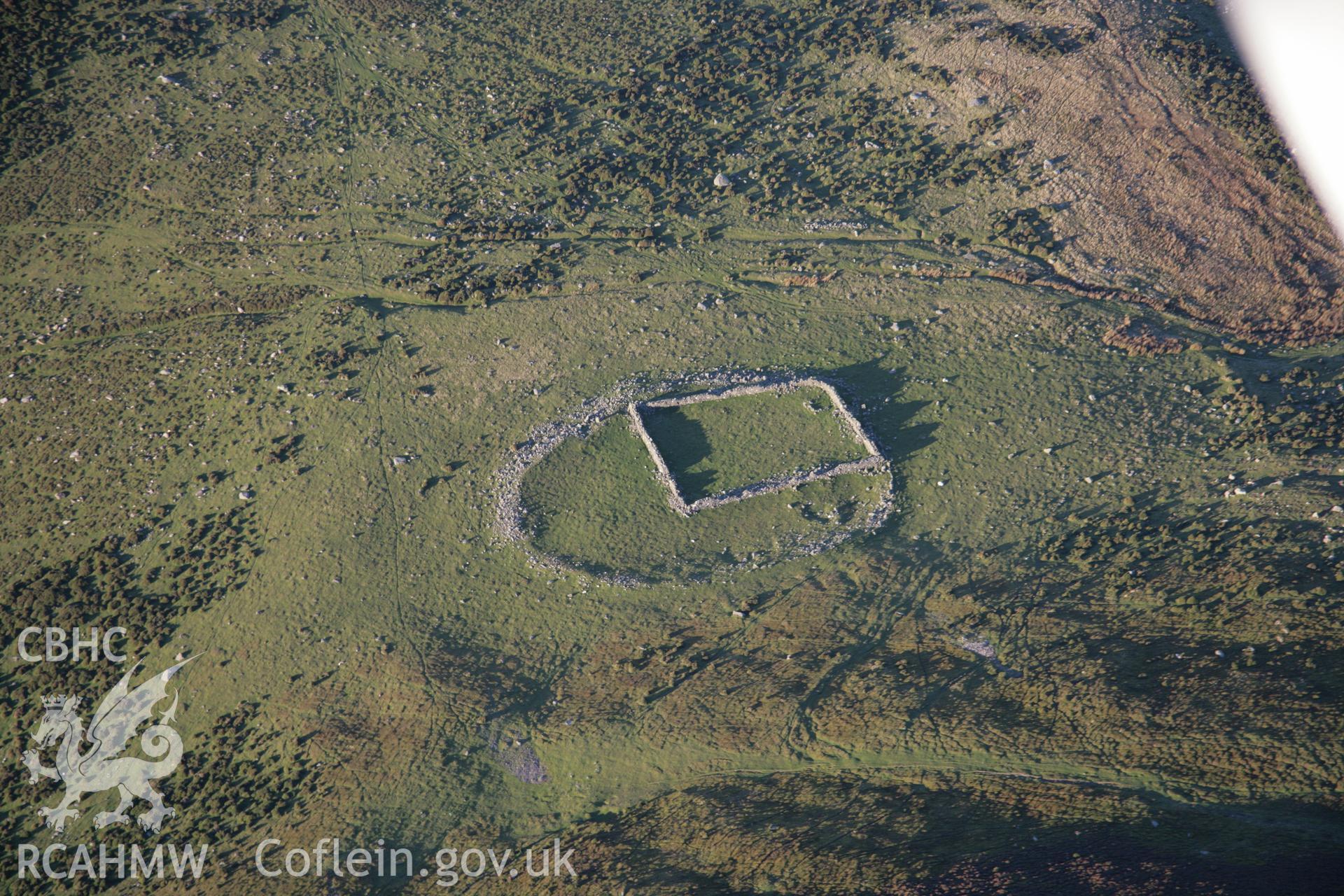 RCAHMW colour oblique aerial photograph of a prehistoric enclosure, with landscape beyond, Foel Dduarth, viewed from the east. Taken on 21 November 2005 by Toby Driver