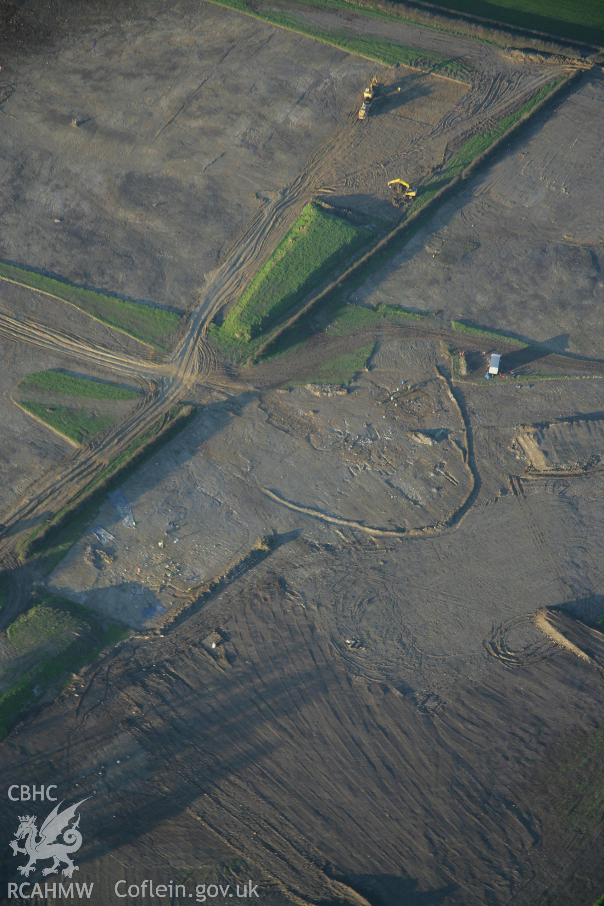 RCAHMW colour oblique aerial photograph showing Parc Bryn Cegin prehistoric settlements under excavation by Gwynedd Archaeological Trust, viewed looking to the north-west Taken on 21 November 2005 by Toby Driver