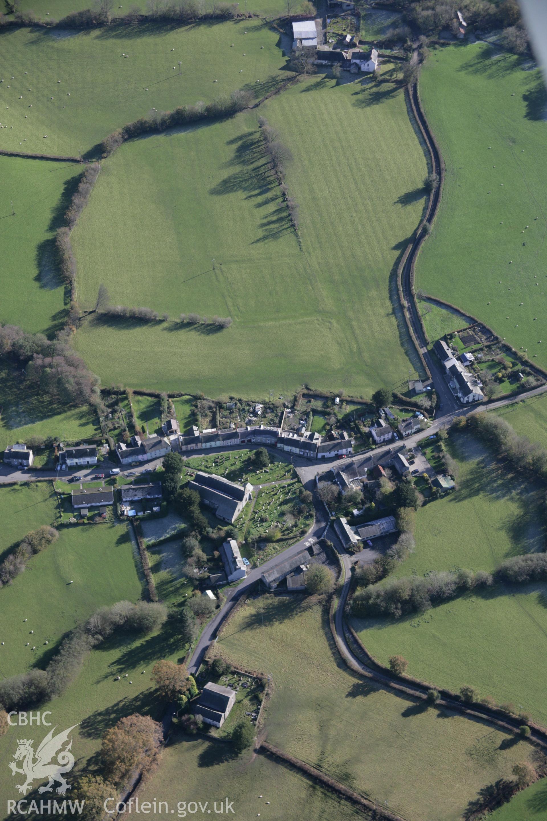RCAHMW colour oblique photograph of Myddfai, St Michael's Church, with earthworks of former outer enclosure, view from north-west. Taken by Toby Driver on 17/11/2005.