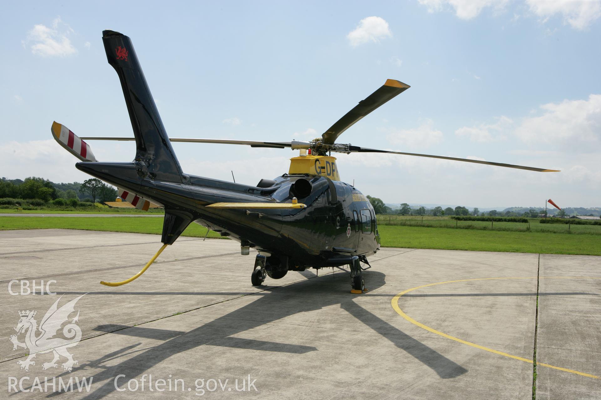RCAHMW colour oblique photograph of police helicopter at Montgomeryshire Mid Wales Airport. Taken by Toby Driver on 01/07/2008.