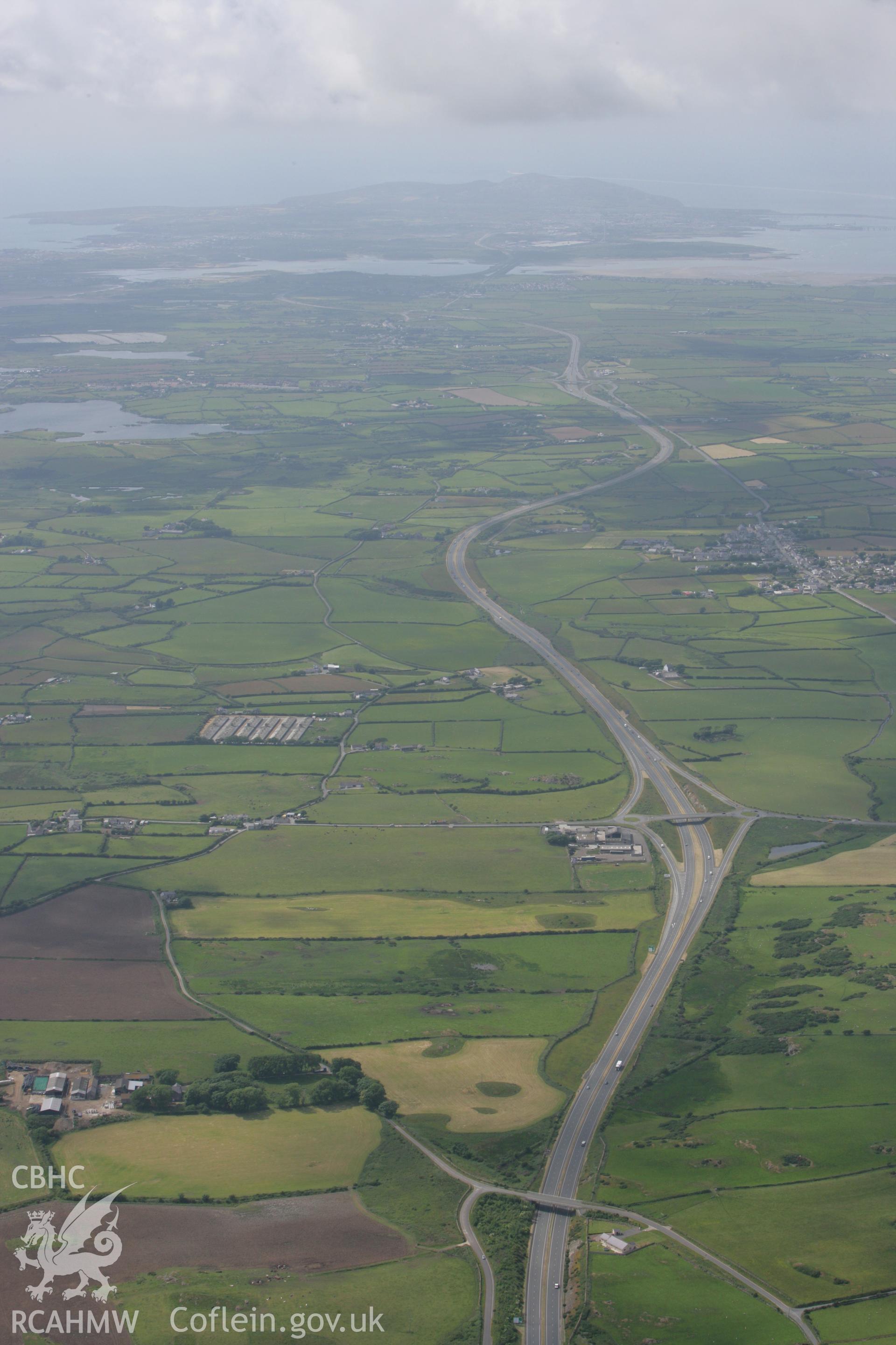 RCAHMW colour oblique photograph of the A55 dual carriageway, Anglesey, looking west towards Holyhead. Taken by Toby Driver on 13/06/2008.
