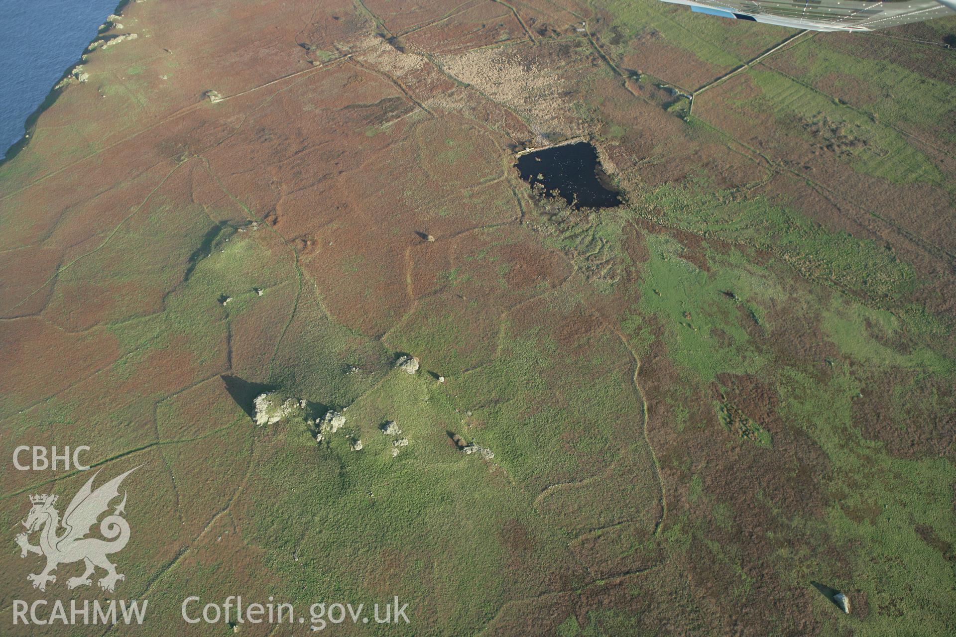 RCAHMW colour oblique photograph of Settlements and field systems, Skomer Island, northern fields and hut groups, from north-west. Taken by Toby Driver on 04/03/2008.