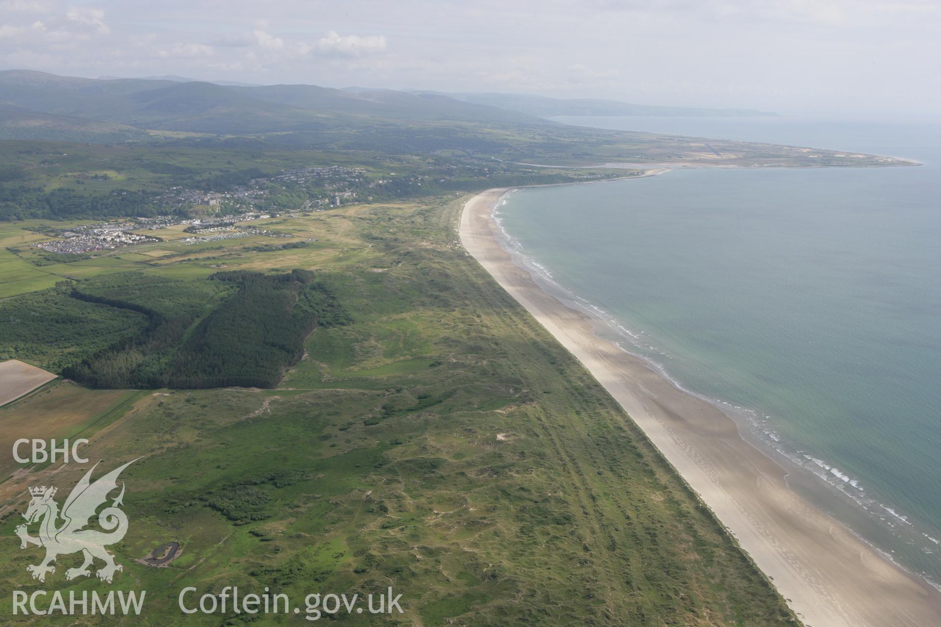 RCAHMW colour oblique photograph of view looking south-east over Hut Circle (near Llechwedd-du-mawr, under forest) towards Harlech. Taken by Toby Driver on 13/06/2008.