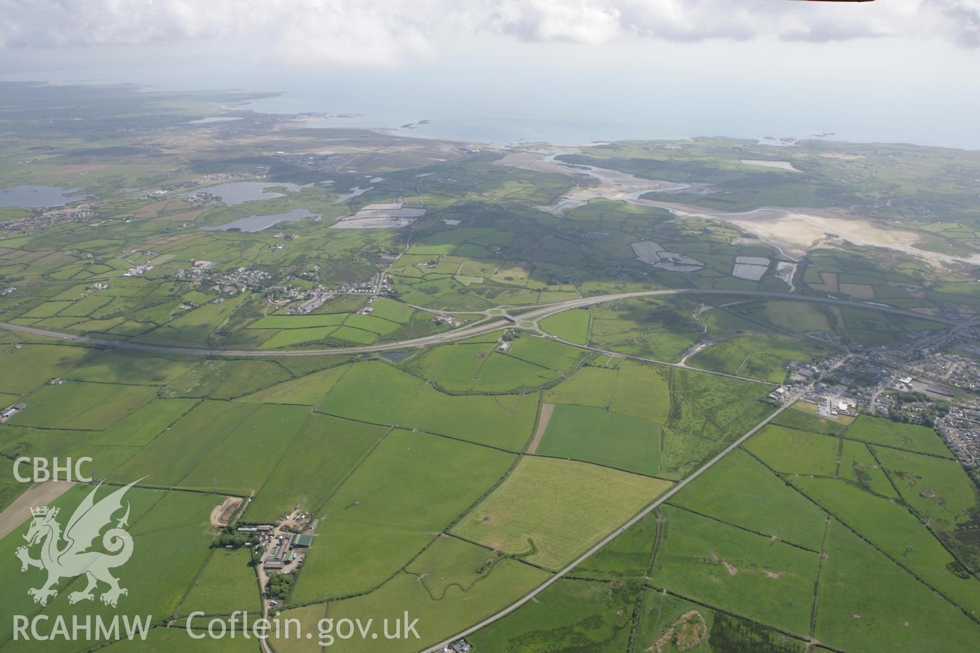 RCAHMW colour oblique photograph of landscape looking south between Caergeiliog and Valley, towards Cymyran Bay. Taken by Toby Driver on 13/06/2008.