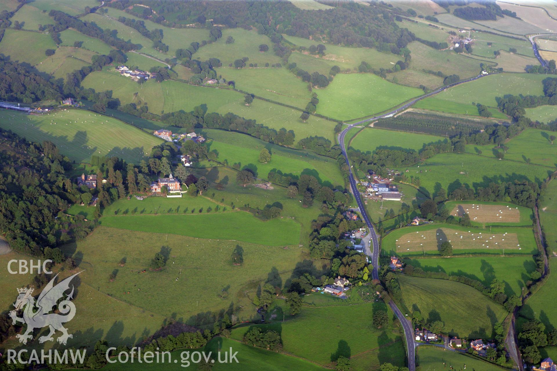 RCAHMW colour oblique photograph of summer landscape looking east towards Cyfronydd Hall. Taken by Toby Driver on 24/07/2008.