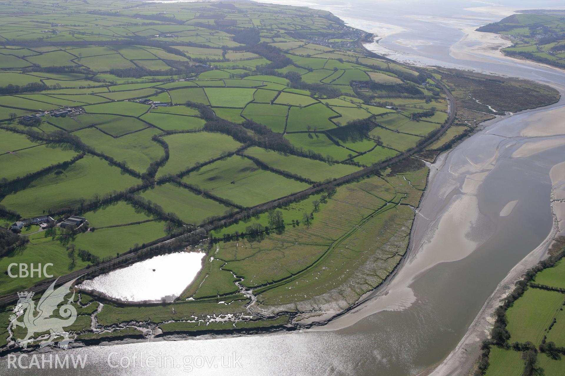 RCAHMW colour oblique photograph of Ferryside village, looking from the north-east along the River Towy. Taken by Toby Driver on 04/03/2008.