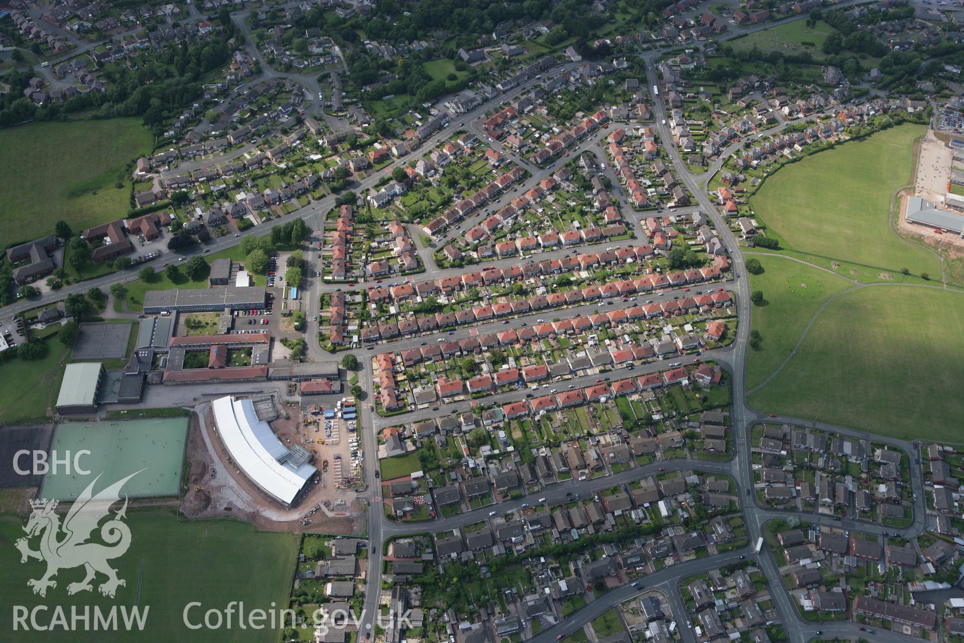 RCAHMW colour oblique photograph of Ysgol Maes Hyfryd, during construction and Flint High School, Flint. Taken by Toby Driver on 01/07/2008.